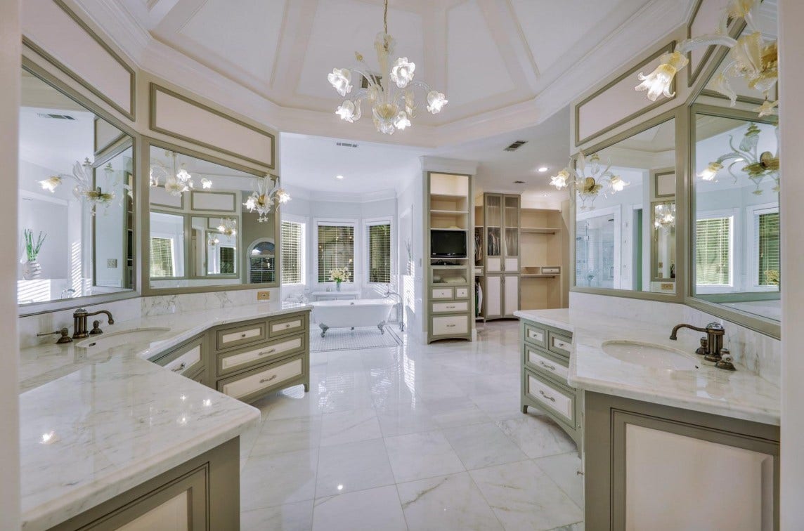 35 W Isle Place, The Woodlands, TX 77381 Expansive primary bathroom with dual vanities, custom storage, and a bright, open layout.