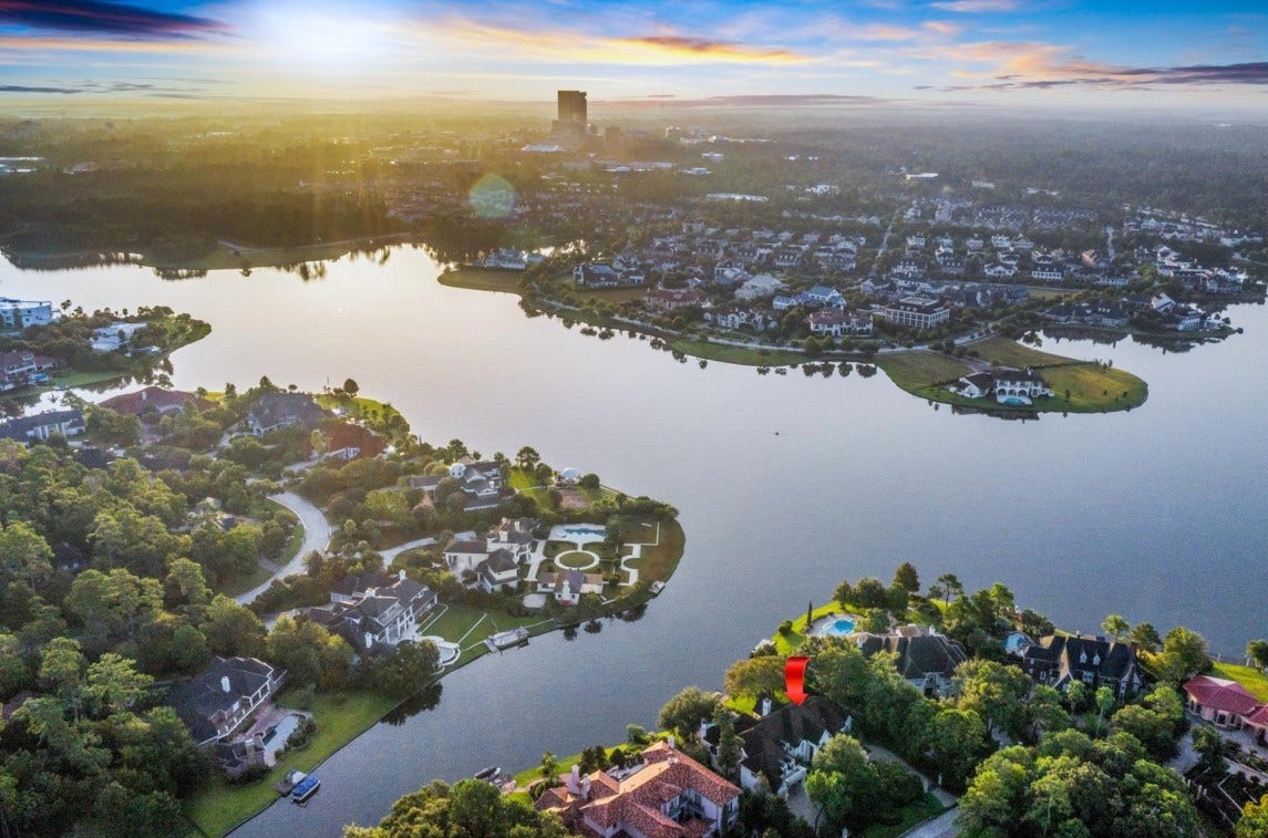 35 W Isle Place, The Woodlands, TX 77381 Spectacular aerial view showcasing the property's prime waterfront location and breathtaking lake views.
