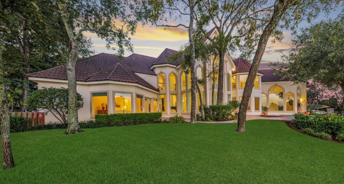 35 W Isle Place, The Woodlands, TX 77381 Beautiful back elevation featuring manicured landscaping and timeless architectural design.