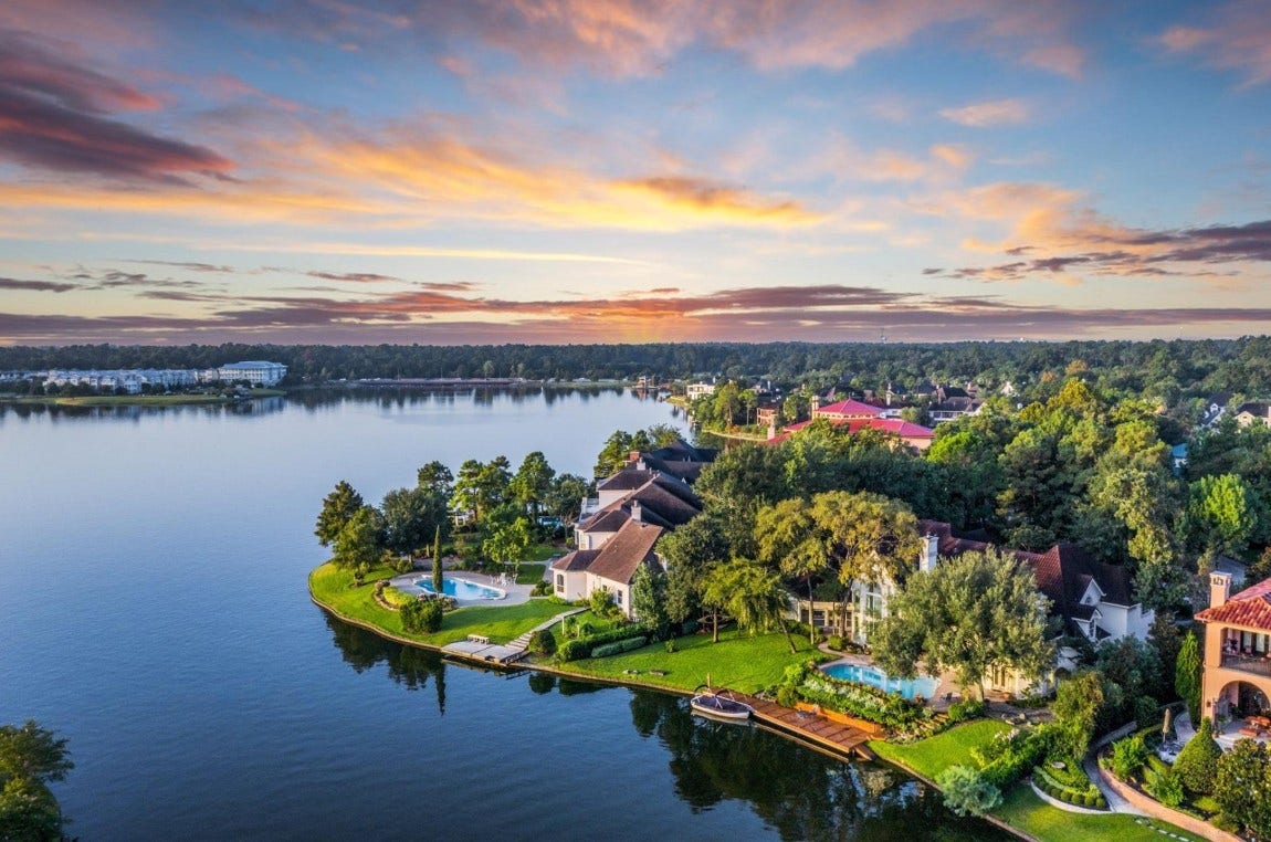 35 W Isle Place, The Woodlands, TX 77381 Waterfront estate with breathtaking sunset views, lush landscaping, and private dock.