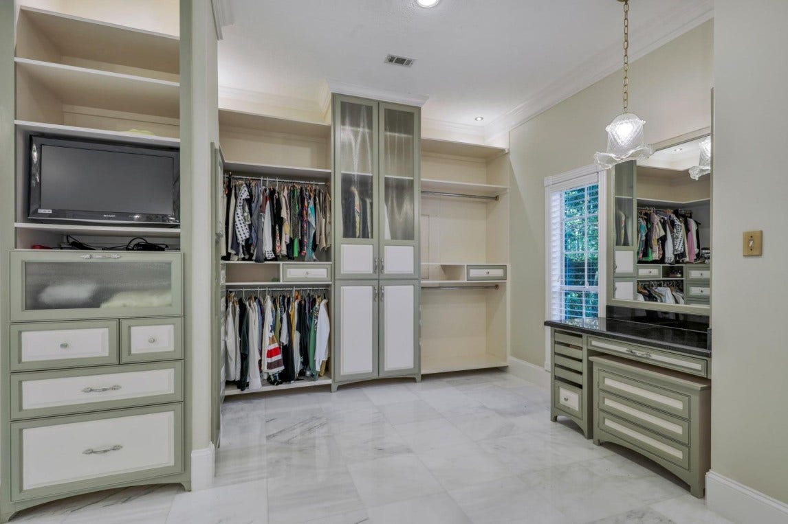 35 W Isle Place, The Woodlands, TX 77381 Spacious walk-in closet with custom built-in shelving, drawers, and abundant storage.