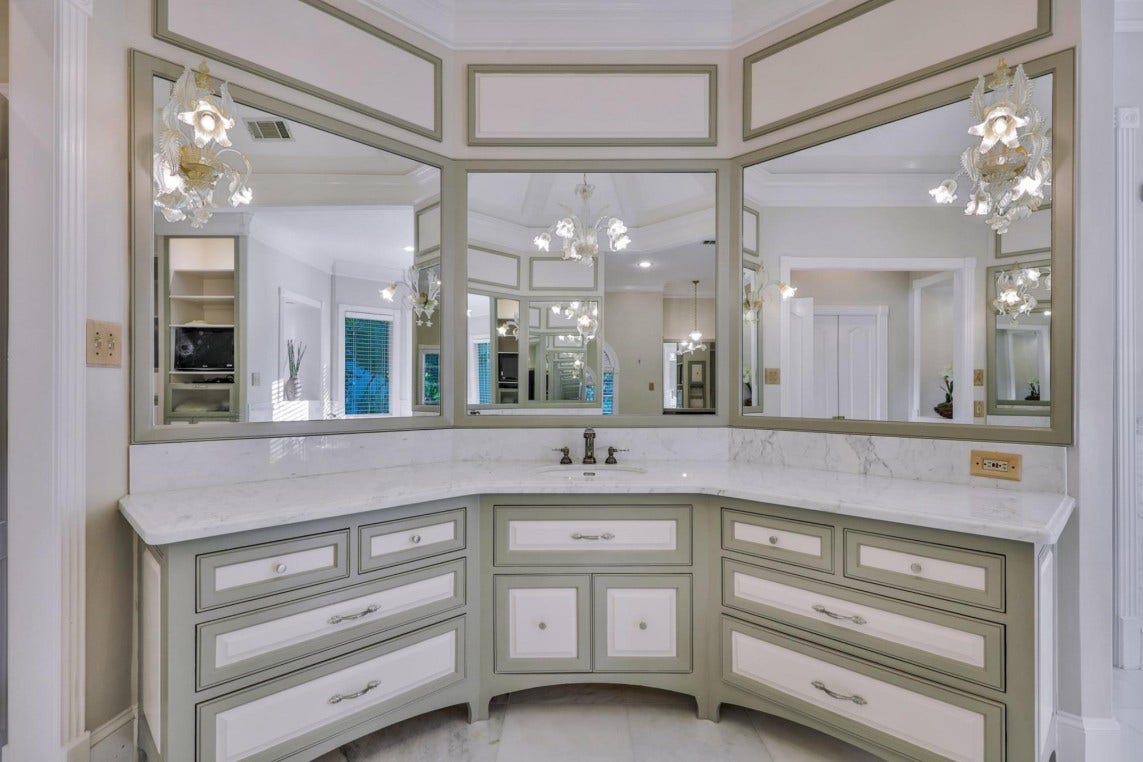 35 W Isle Place, The Woodlands, TX 77381 Luxurious primary bath vanity with dual sinks, custom cabinetry, and elegant finishes