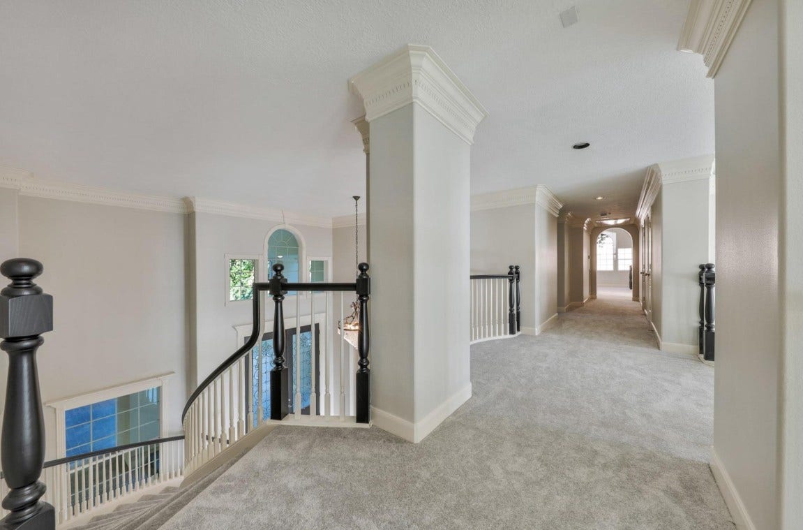35 W Isle Place, The Woodlands, TX 77381 Spacious upstairs landing with elegant staircase and easy access to secondary living area