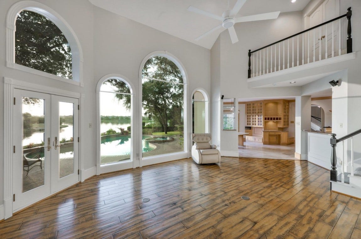 35 W Isle Place, The Woodlands, TX 77381 Grand living area with arched windows, and abundant natural light.