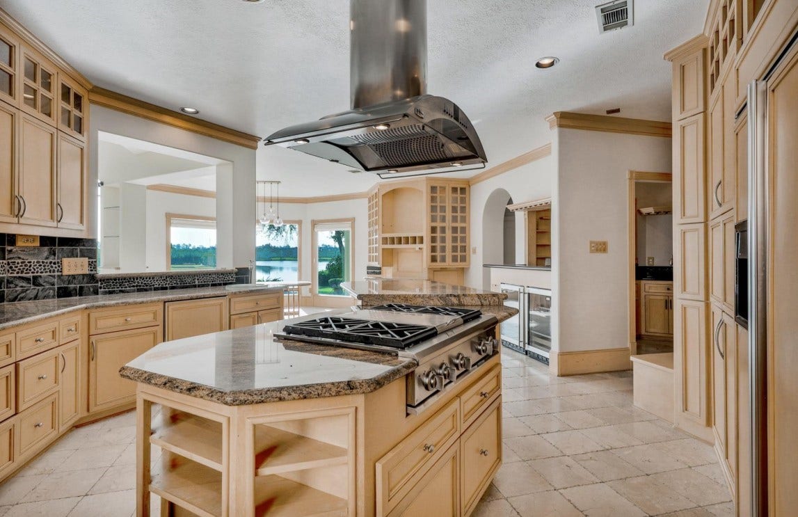 35 W Isle Place, The Woodlands, TX 77381 Gourmet kitchen featuring custom cabinetry, premium appliances, and a large center island.