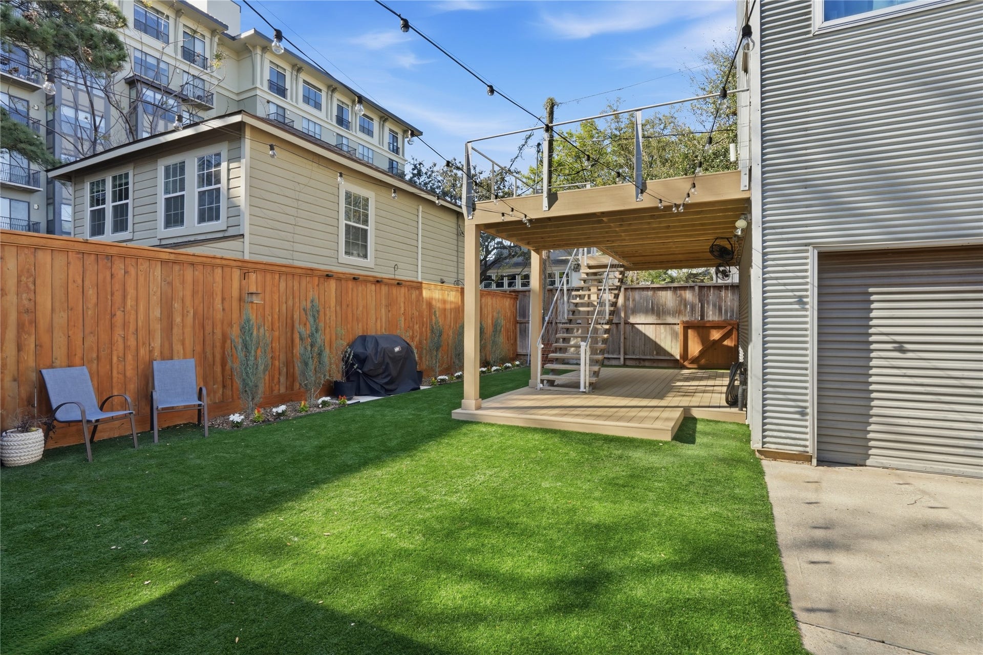 Low-maintenance backyard with durable turf, fenced privacy, and space for outdoor seating or play.