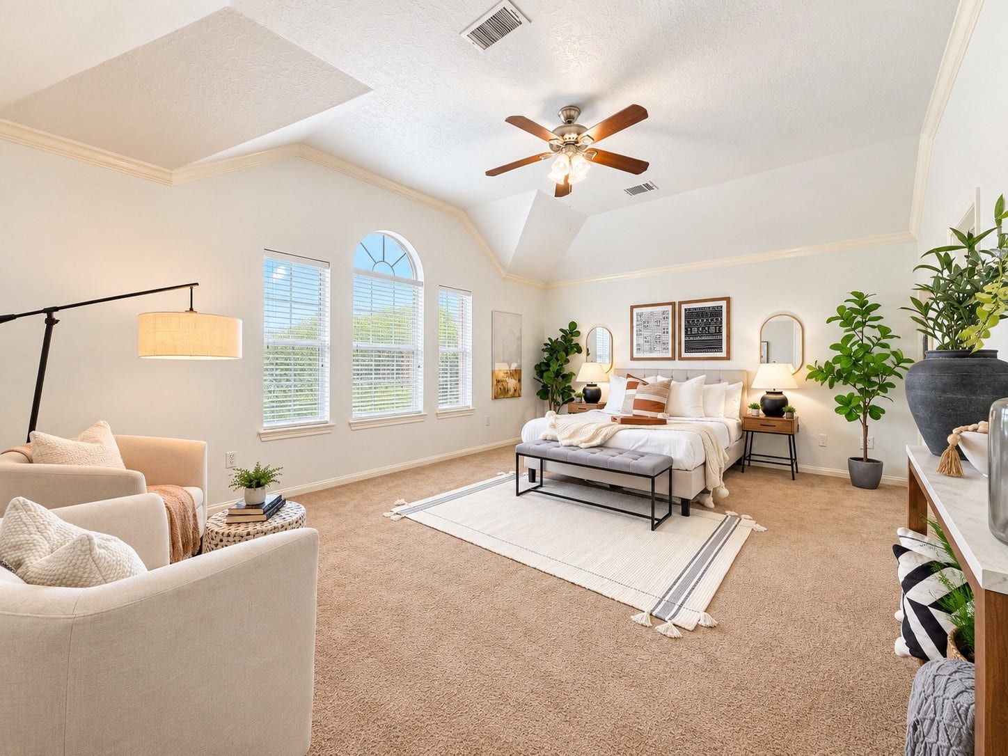 21418 Avalon Queen Drive, Spring, TX 77379 Spacious primary bedroom with abundant natural light, cozy seating area, and elegant decor for ultimate relaxation.