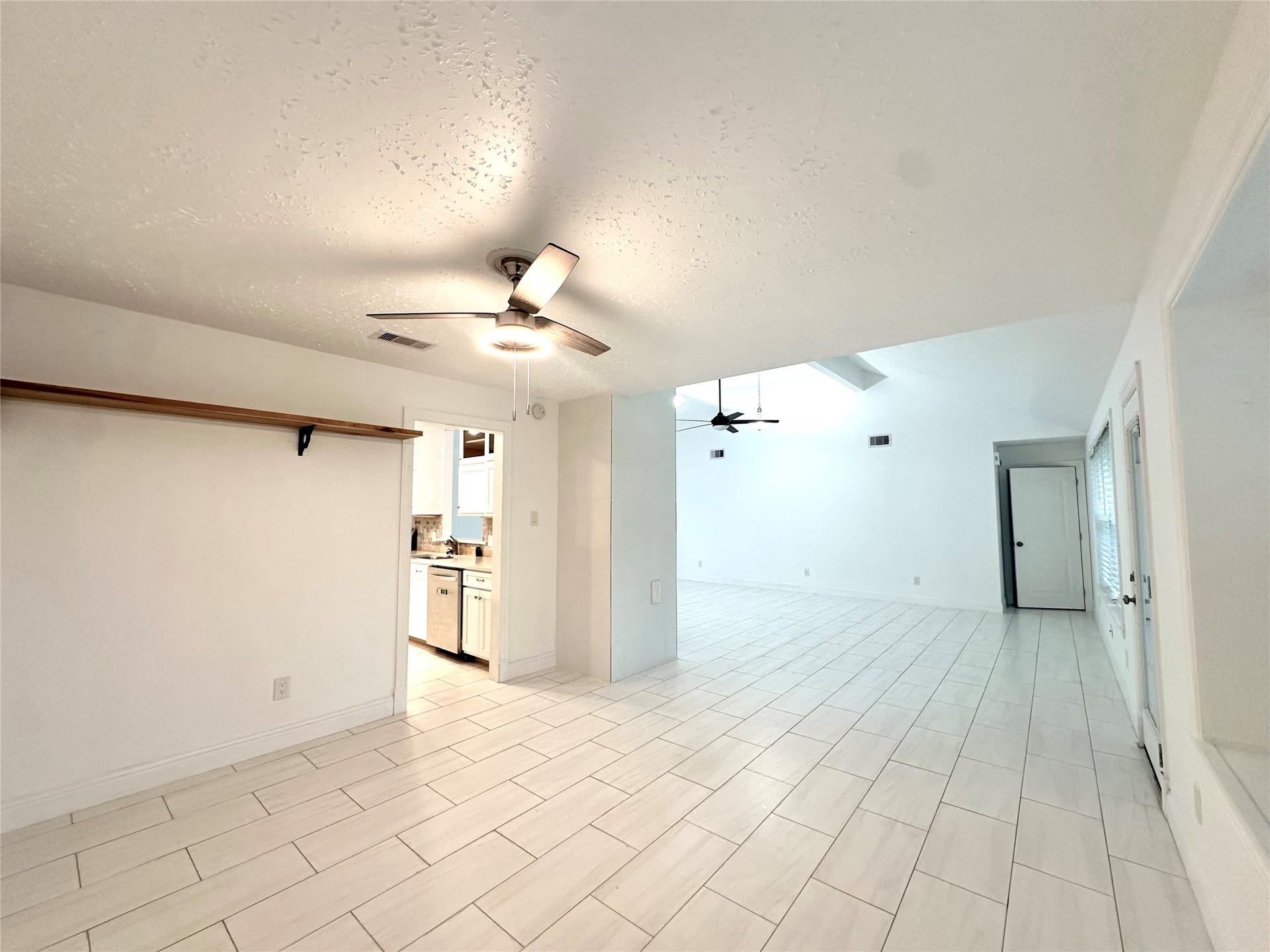 3411 Cannon Ridge Drive, Richmond, TX 77406 Modern kitchen with sleek stainless steel appliances, a large central island with seating, and ample natural light from large windows.