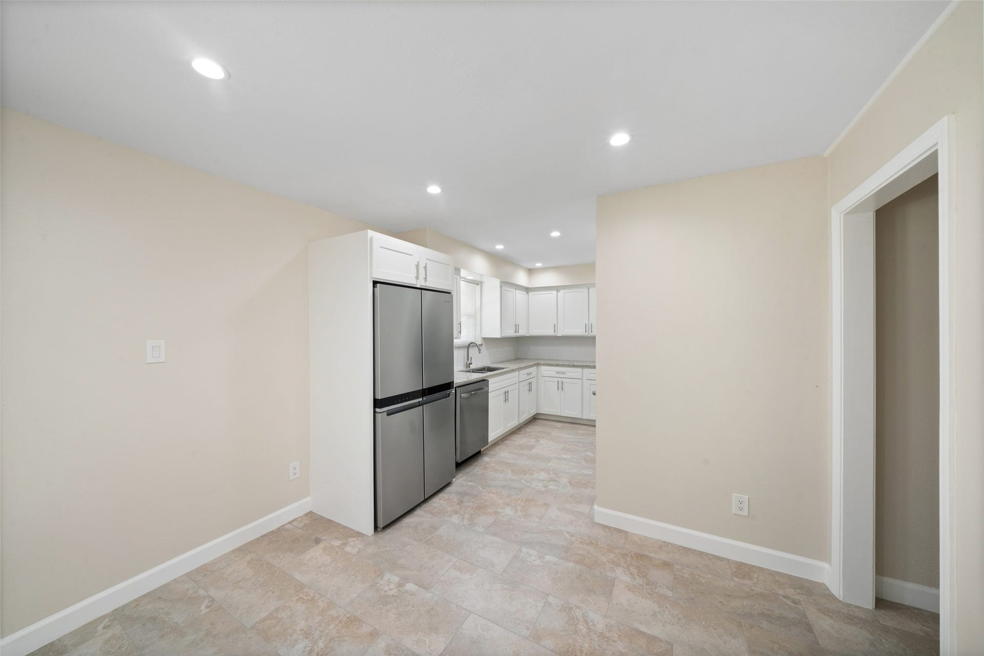 3402 Dovie Drive, Spring, TX 77380 This beautifully remodeled kitchen features bright cabinetry, Dallas White granite countertops, and a clean, updated layout designed for both style and function.