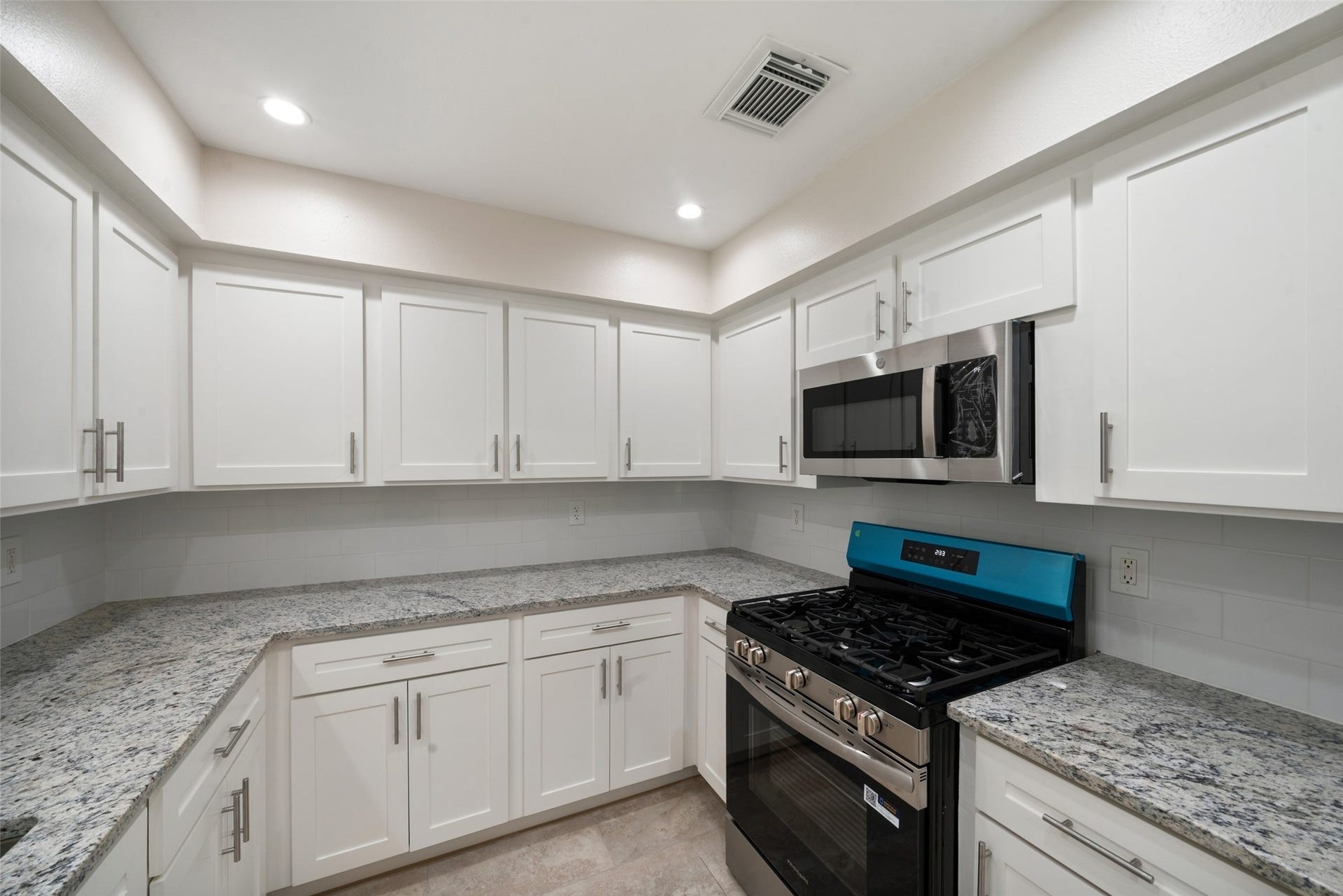 3402 Dovie Drive, Spring, TX 77380 Upgrades include modified cabinets, a gas range, dishwasher, built-in microwave, double-deep sink, Moen brushed nickel faucet, and garbage disposal, creating a polished and practical space ready for everyday cooking and entertaining.