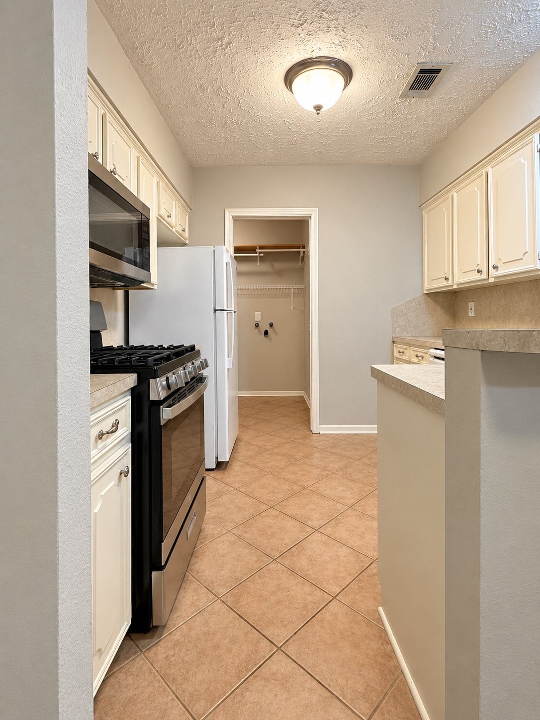 26415 Pine Canyon Drive, Spring, TX 77380 Looking in from breakfast nook to kitchen and utility room. Two refrigerators are included - one in kitchen and the other in the garage.