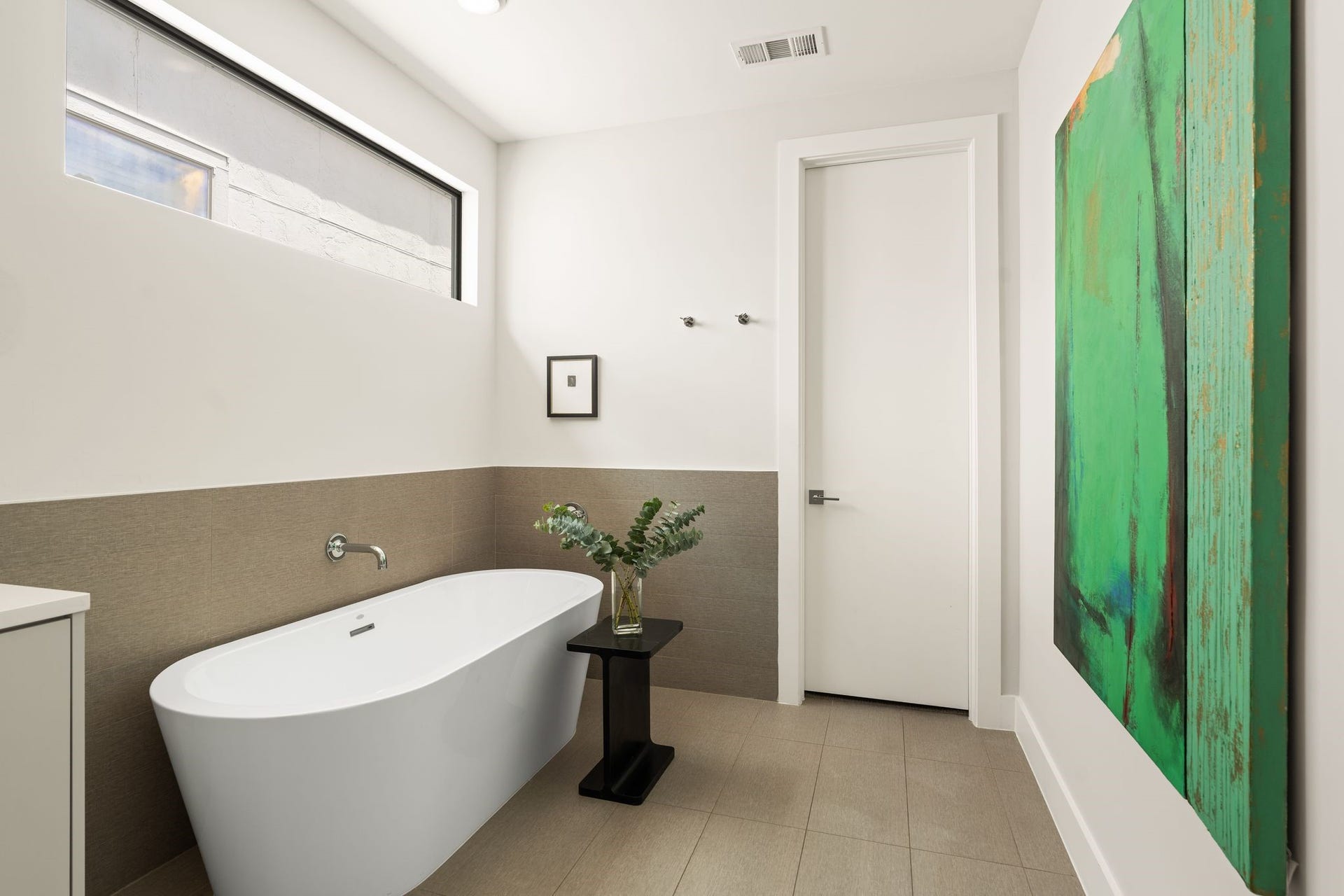 2622 Greenbriar Drive, Houston, TX 77098 Spa-inspired primary bathroom features a freestanding soaking tub, generous wall space for artwork, and direct access to the expansive walk-in closet.