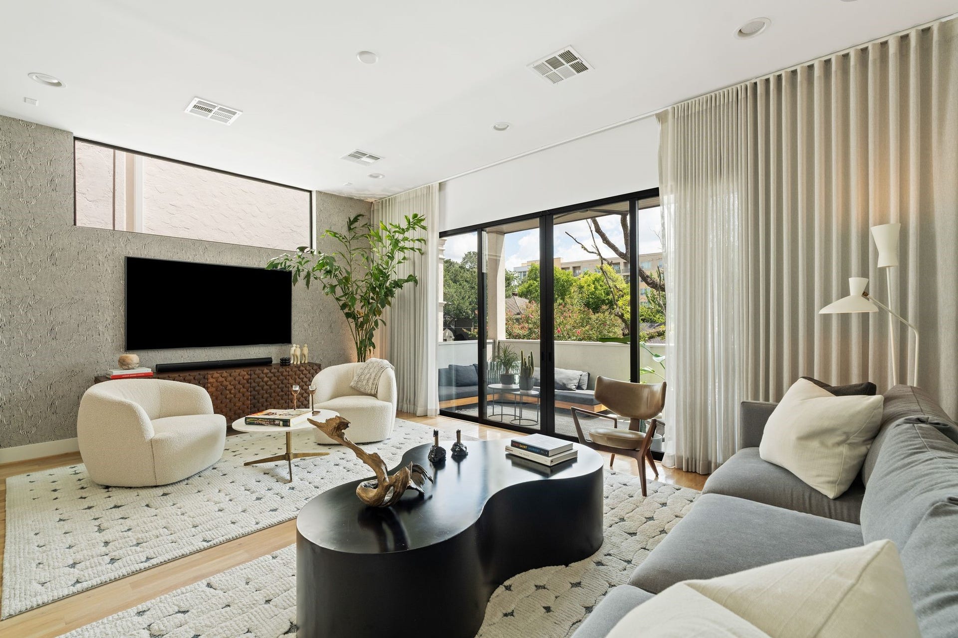 2622 Greenbriar Drive, Houston, TX 77098 Another perspective of the expansive living room highlights abundant natural light and sliding glass doors opening directly to the covered terrace.