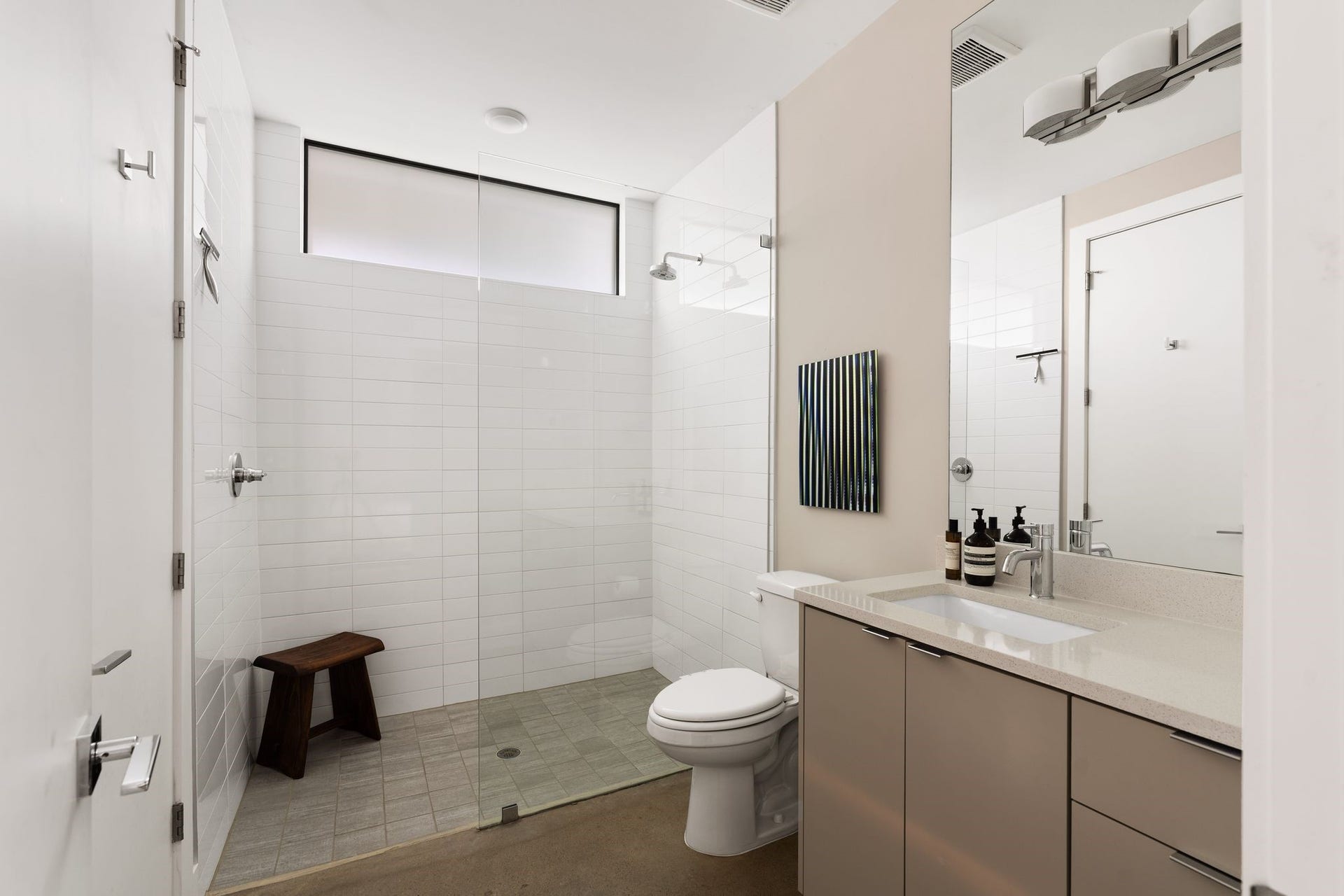 2622 Greenbriar Drive, Houston, TX 77098 Sleek first-floor full bath with a glass-enclosed walk-in shower, contemporary finishes, and a spacious vanity with abundant cabinetry and drawer storage.