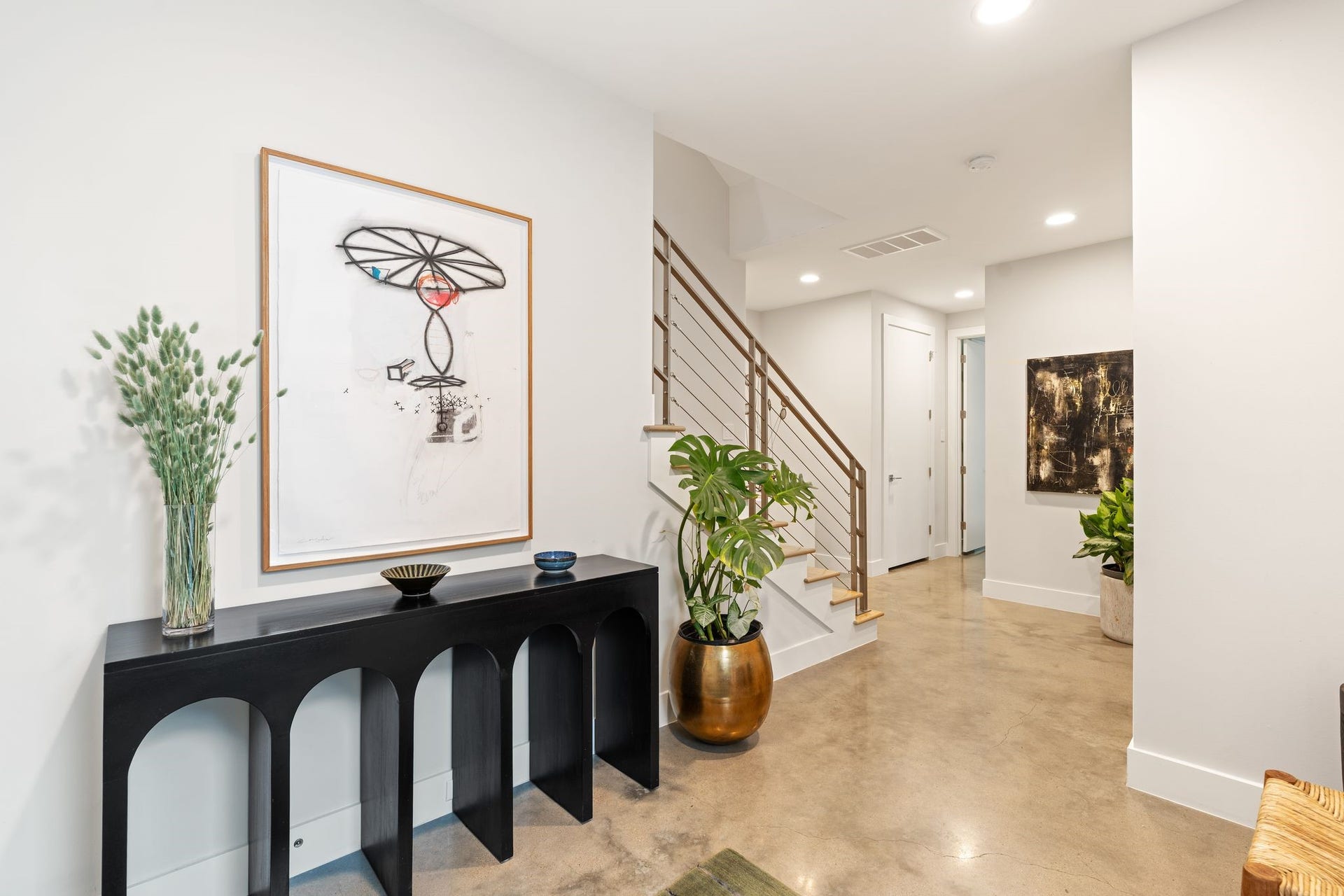 2622 Greenbriar Drive, Houston, TX 77098 A generous foyer creates a sophisticated arrival with polished concrete floors, contemporary stair detailing, and ample space for furnishings or art.
