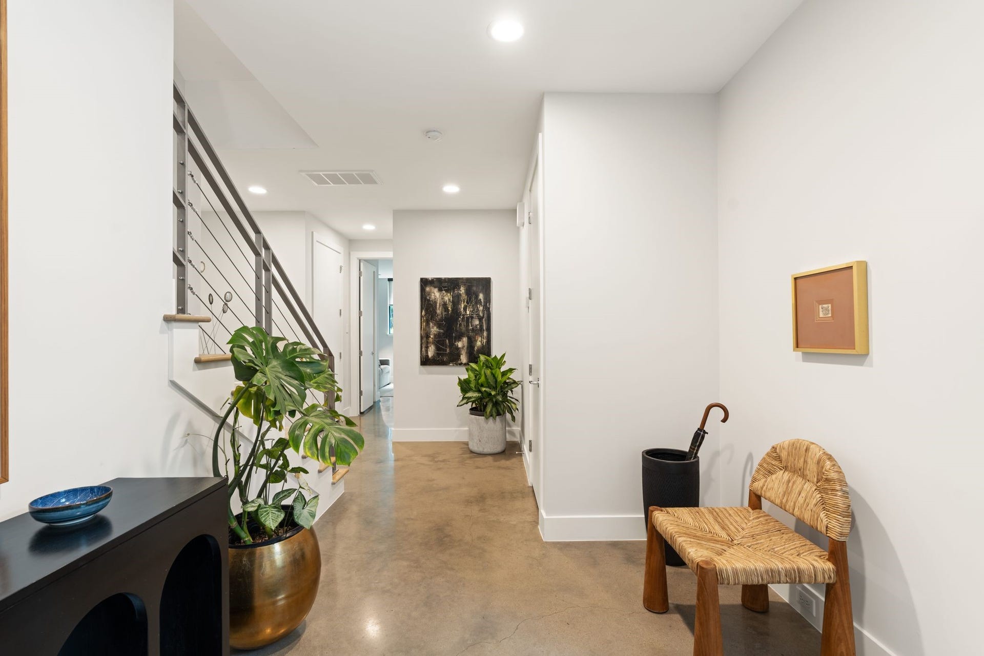 2622 Greenbriar Drive, Houston, TX 77098 Spacious first-floor entry with design-forward concrete floors, high ceilings, and convenient access to the garage and two secondary bedrooms.