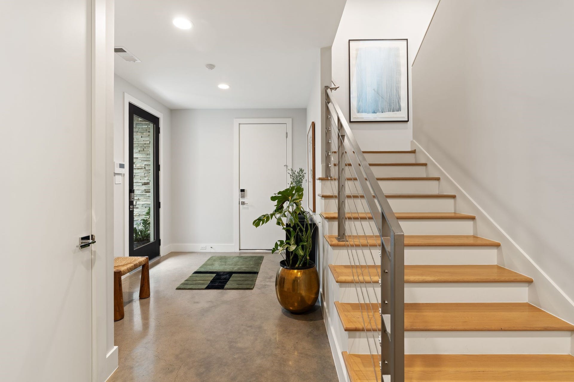 2622 Greenbriar Drive, Houston, TX 77098 Contemporary stairway leads from the first-floor entry to the homes light-filled second-floor living and entertaining spaces.