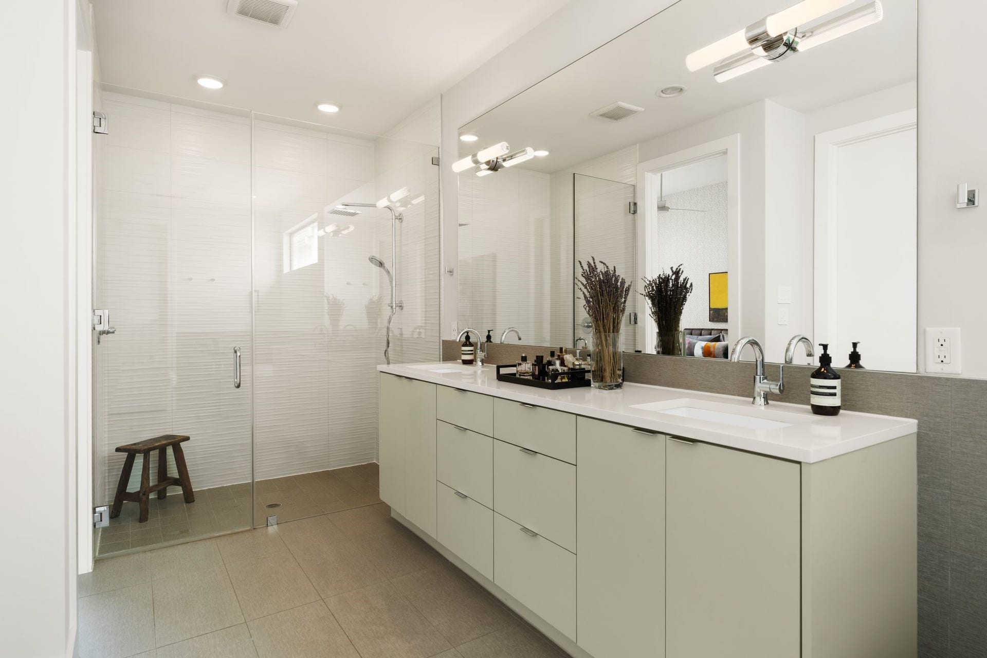 2622 Greenbriar Drive, Houston, TX 77098 Luxurious primary bath with high ceilings, glass-enclosed shower, expansive double-sink vanity, and abundant custom cabinetry and drawer storage.