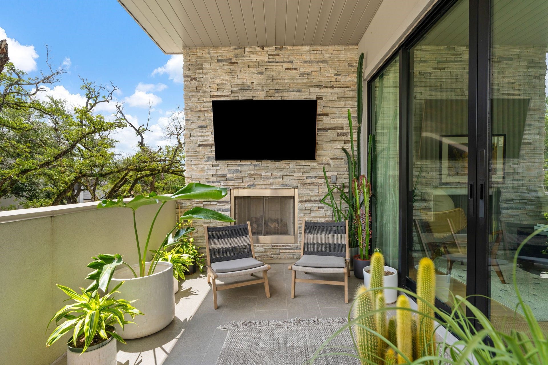 2622 Greenbriar Drive, Houston, TX 77098 Covered second-floor terrace with fireplace, television, built-in audio, and direct access to the living room creates an inviting extension of the homes entertaining spaces.