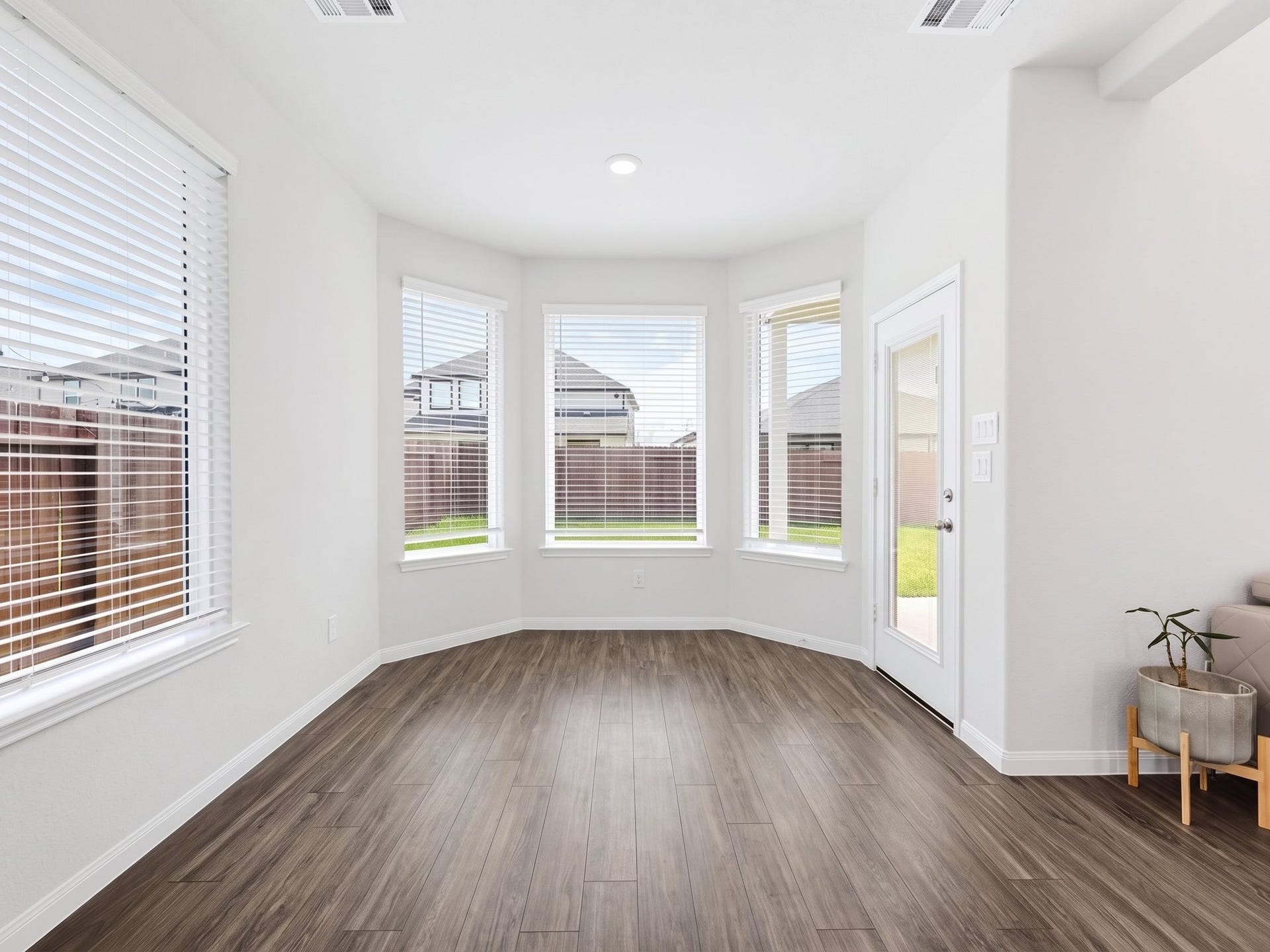 The spacious dining area is filled with abundant natural light and comfortably accommodates a 63-inch dining table.