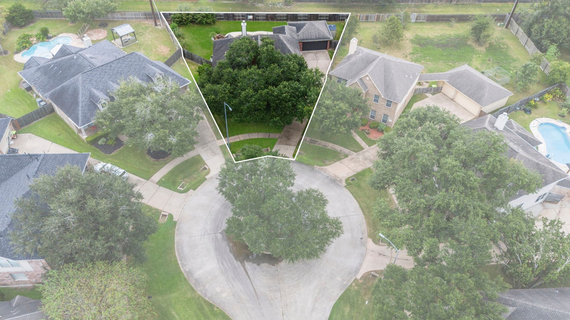 9730 Harrison Lane, Missouri City, TX 77459 Street-level front facade featuring the classic red brick and stone stone exterior, mature canopy shade trees, stone-rimmed flower beds, and long driveway access.