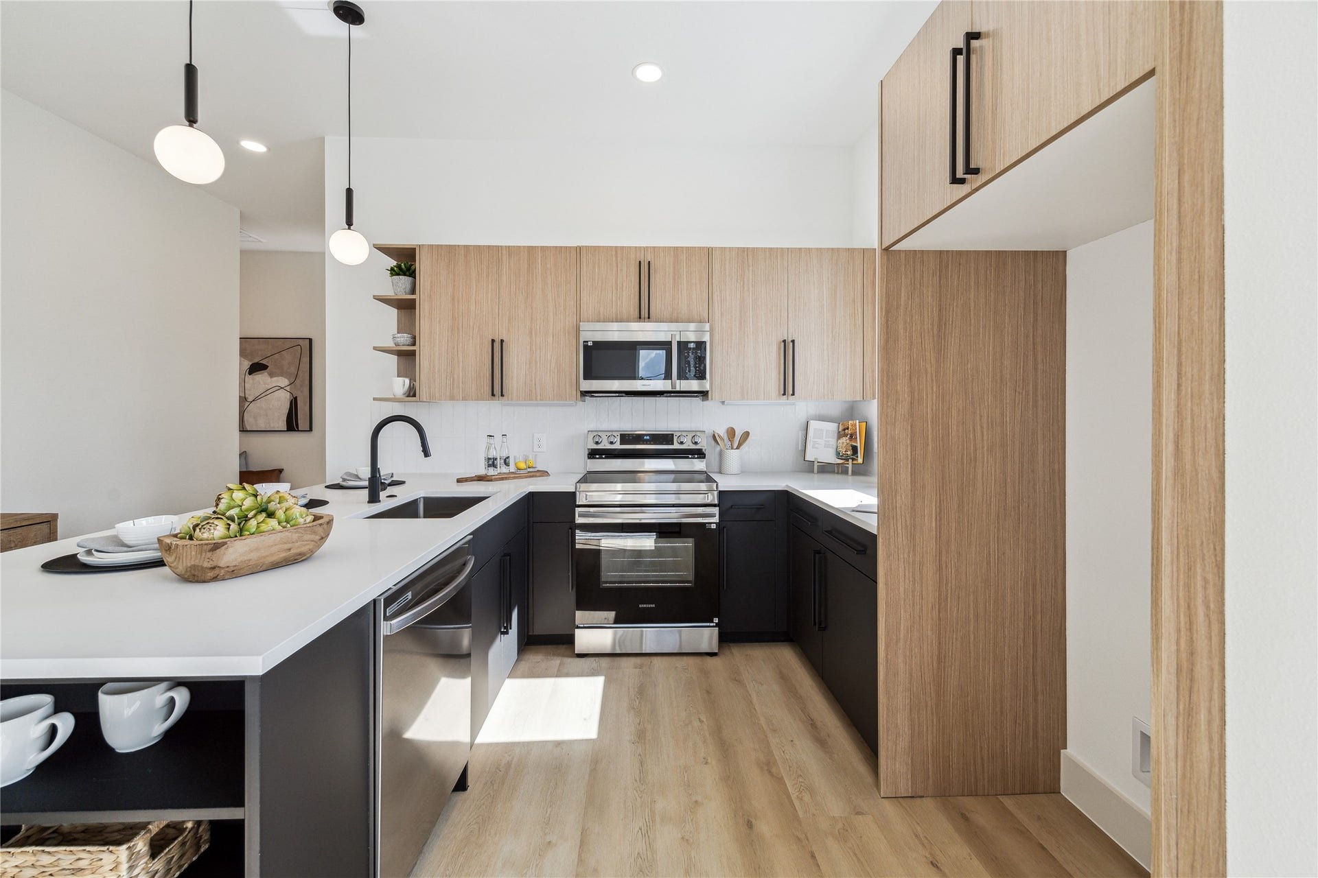 4415 Buck Street, #A/B, Houston, TX 77020 Modern kitchen featuring European styled cabinetry, quartz coubntertops, and under cabinet lighting for a sleek and functional space.