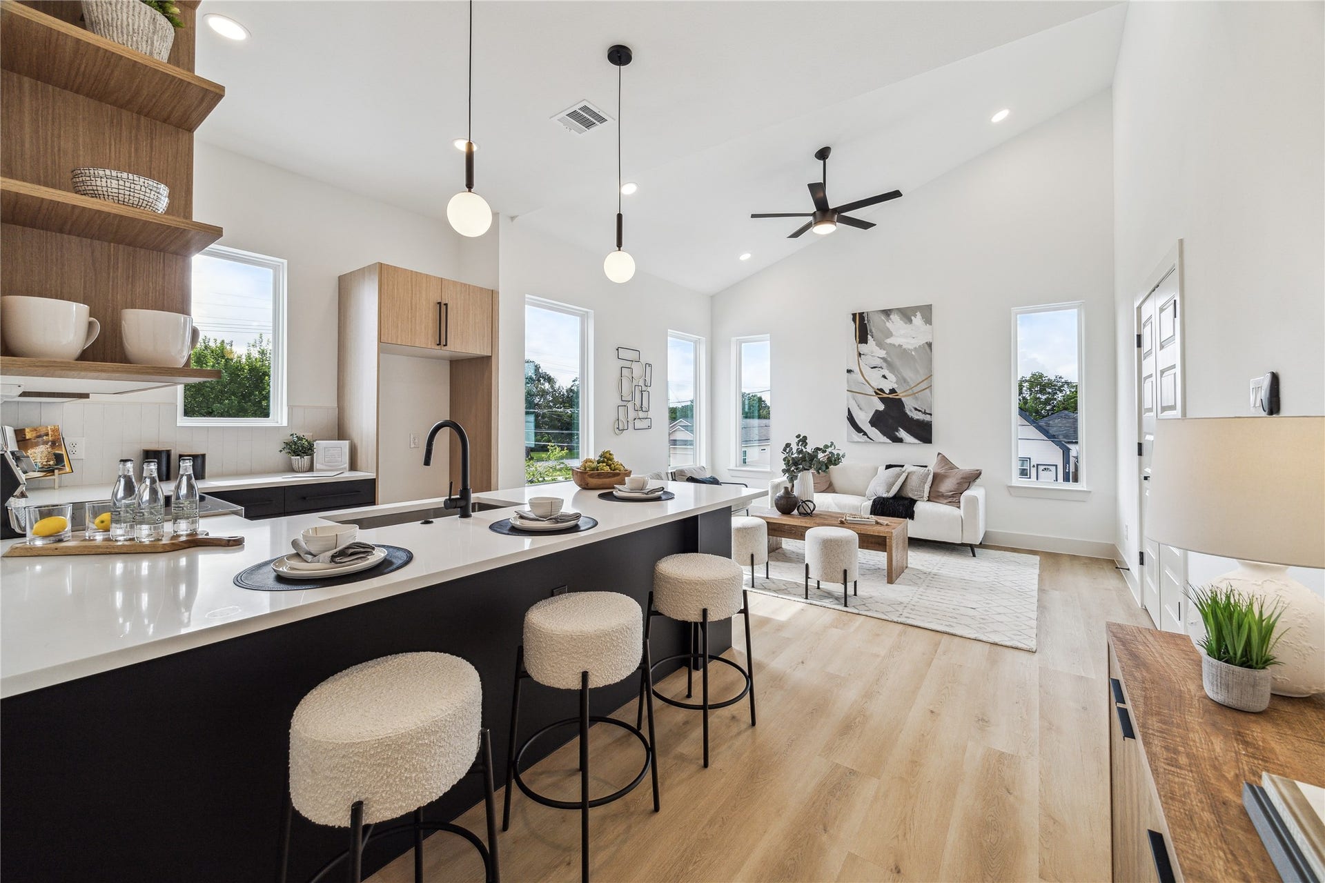 4415 Buck Street, #A/B, Houston, TX 77020 Modern kitchen island showcasing quartz countertops, clean lines, and stylish space designed for entertaining. Built in shelving providing additional storage and a stylish focal point for the space.