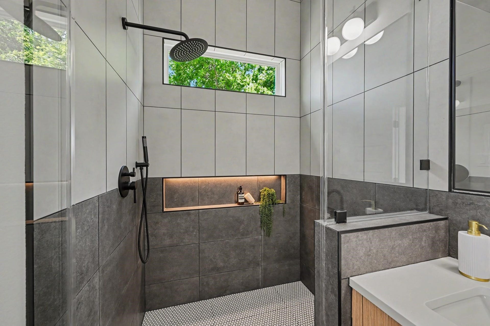 4415 Buck Street, #A/B, Houston, TX 77020 Intentional design featuring a recessed-lit shower niche, blending everyday functionality with elevated style.