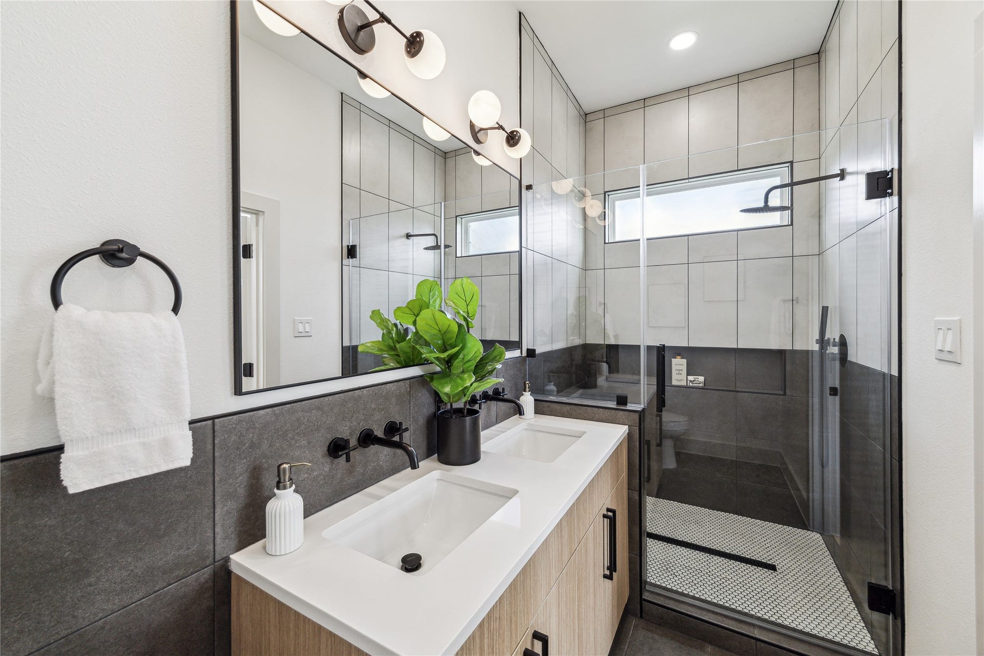 4415 Buck Street, #A/B, Houston, TX 77020 spa inspired primary bathroom featuring modern finishes, spacious shower and illuminated shower niche.