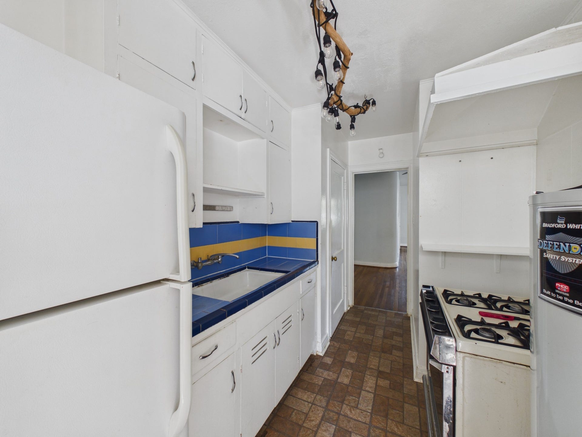 Kitchen with Retro Tiled Counter and Ornate Lighting