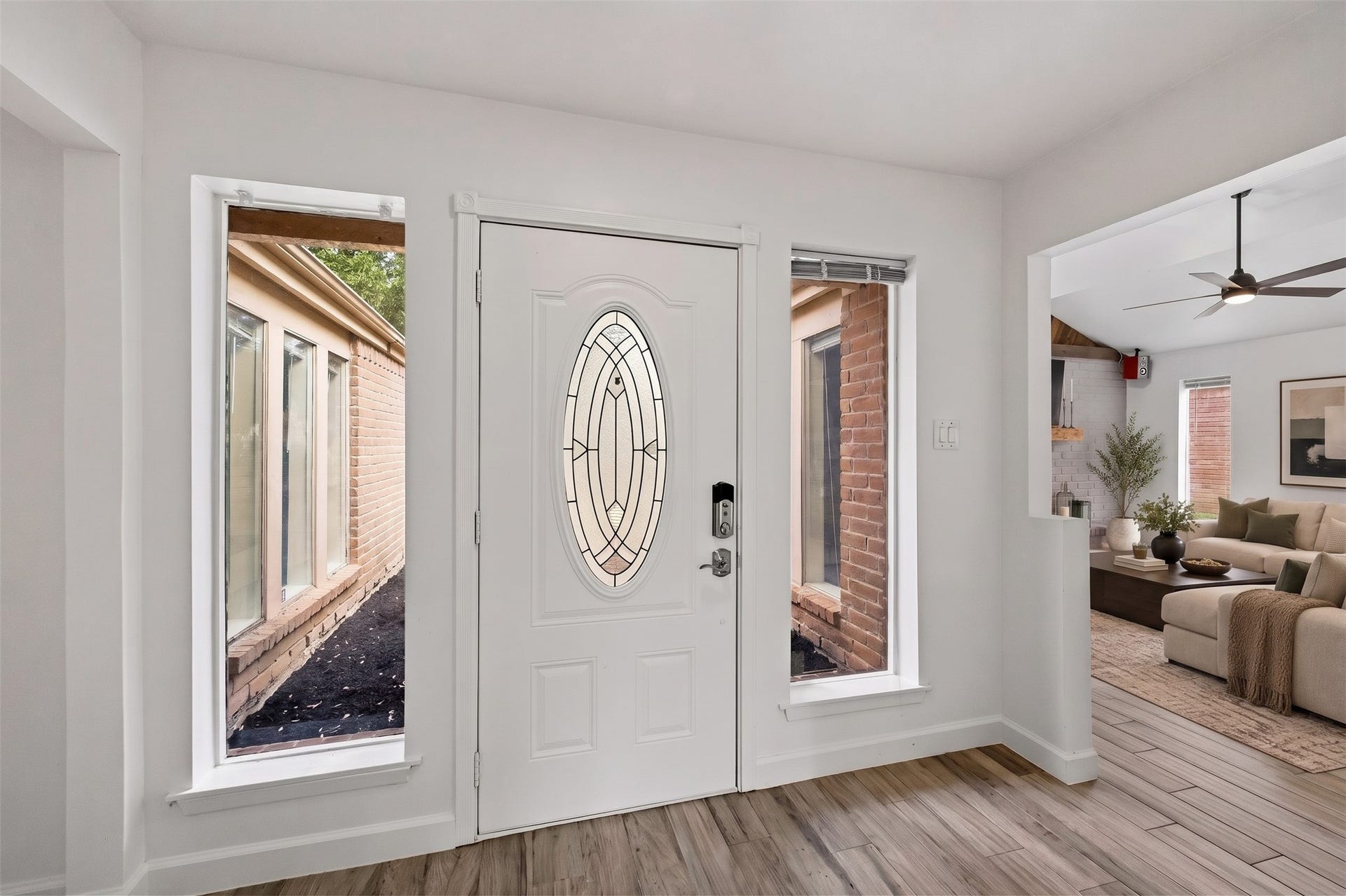 22711 Provincial Boulevard, Katy, TX 77450 Virtually Staged: A bright and welcoming entryway greets you with high ceilings and an expansive, sun-drenched feel. Floor-to-ceiling windows showcase the charming brick-lined courtyard outside while filling the interior with vibrant daylight.