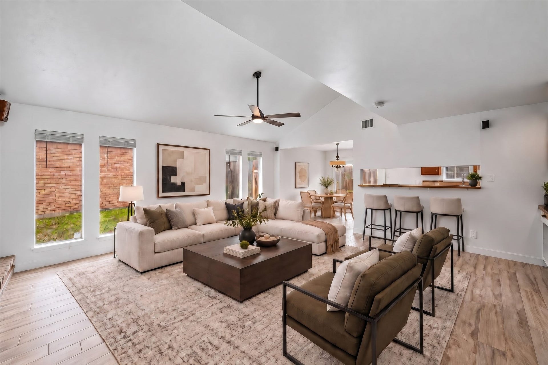22711 Provincial Boulevard, Katy, TX 77450 Virtually Staged: The sweeping ceiling line enhances the room's open footprint, while the built-in serving bar provides a natural transition into the adjacent entertaining and dining areas.