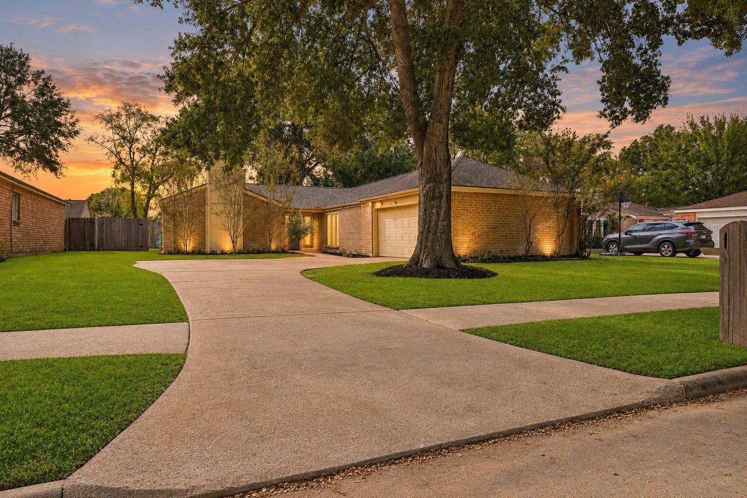 22711 Provincial Boulevard, Katy, TX 77450 Welcome to this warm and inviting single-story residence, beautifully set back on an expansive front lot that feels like home the moment you arrive. A sweeping, curved driveway provides generous parking for family and guests, creating a grand yet friendly approach to the house.
