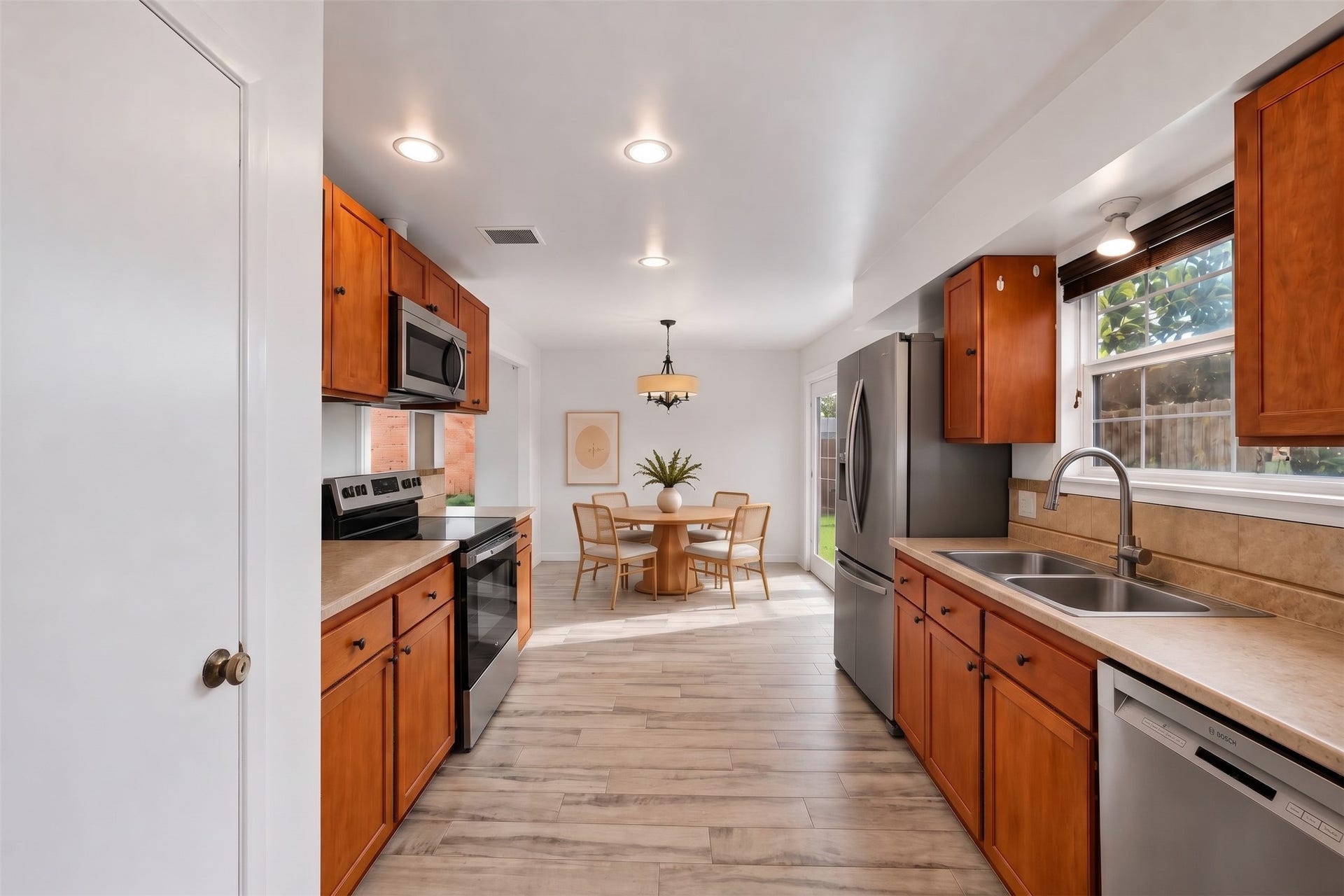 22711 Provincial Boulevard, Katy, TX 77450 Virtually Staged: Thoughtfully planned with ample room to move, this inviting culinary space seamlessly unites practical prep areas with an open dining alcove.