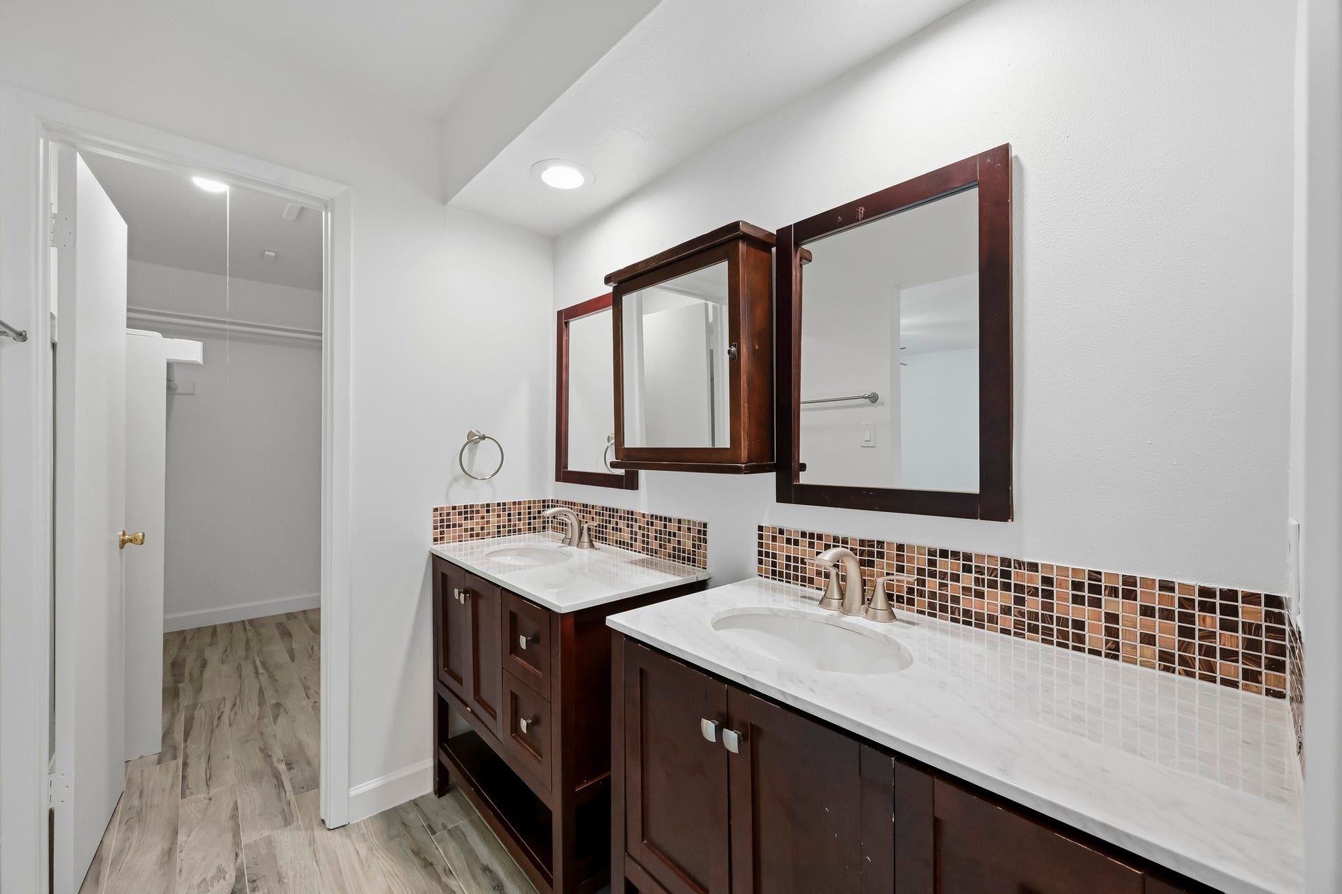 22711 Provincial Boulevard, Katy, TX 77450 Designed for effortless morning routines, this spacious ensuite bath features two distinct vanity stations with substantial counter room and under-sink cabinetry, and flows smoothly into an expansive closet area.