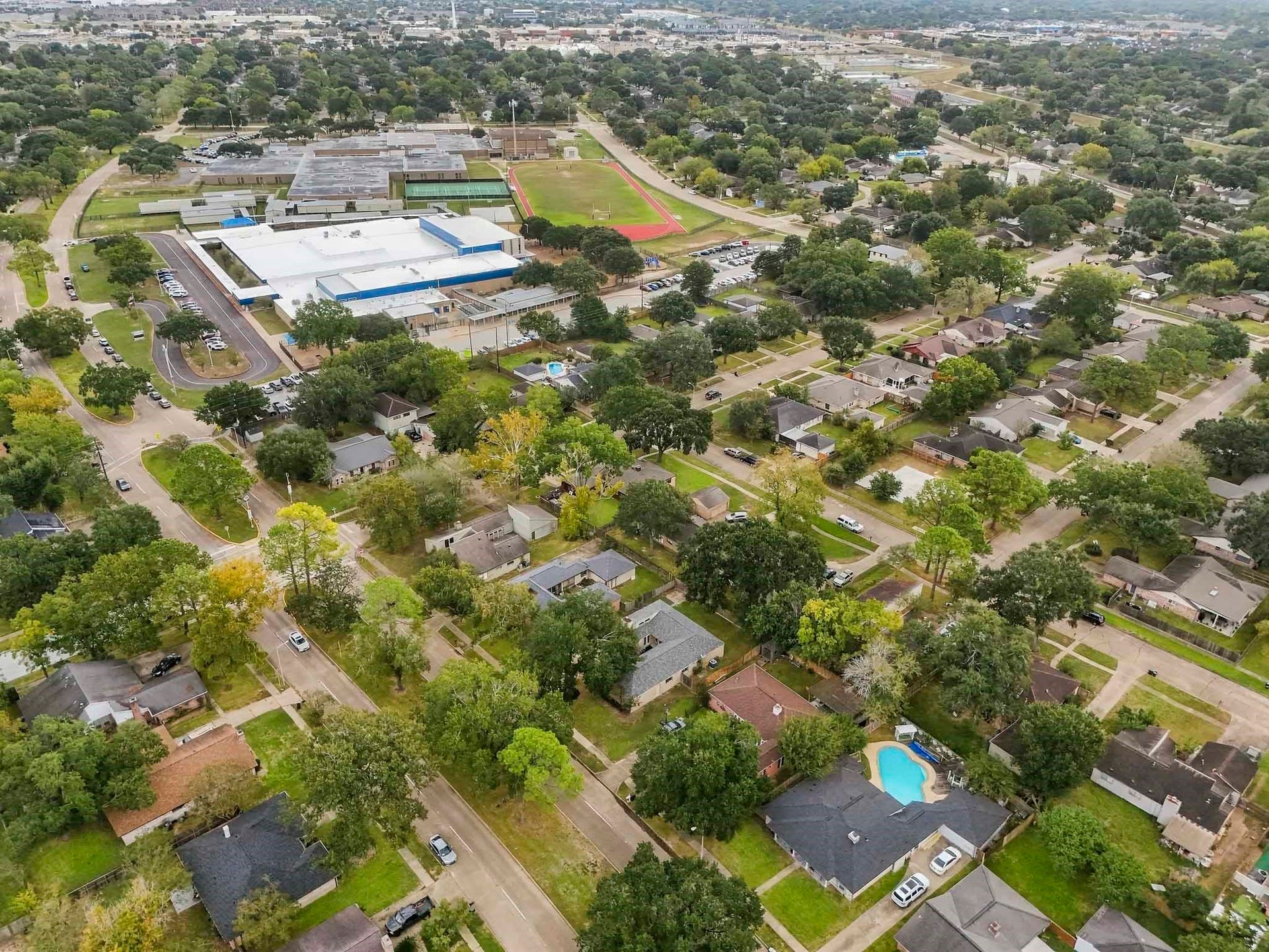 22711 Provincial Boulevard, Katy, TX 77450 Overlooking the vibrant surrounding enclave, this high-angle vista emphasizes the remarkable appeal and community-centric location of the residence. Combining a tranquil neighborhood atmosphere with unbeatable convenience to schools and open-air activities, this property enjoys an enviable setting.