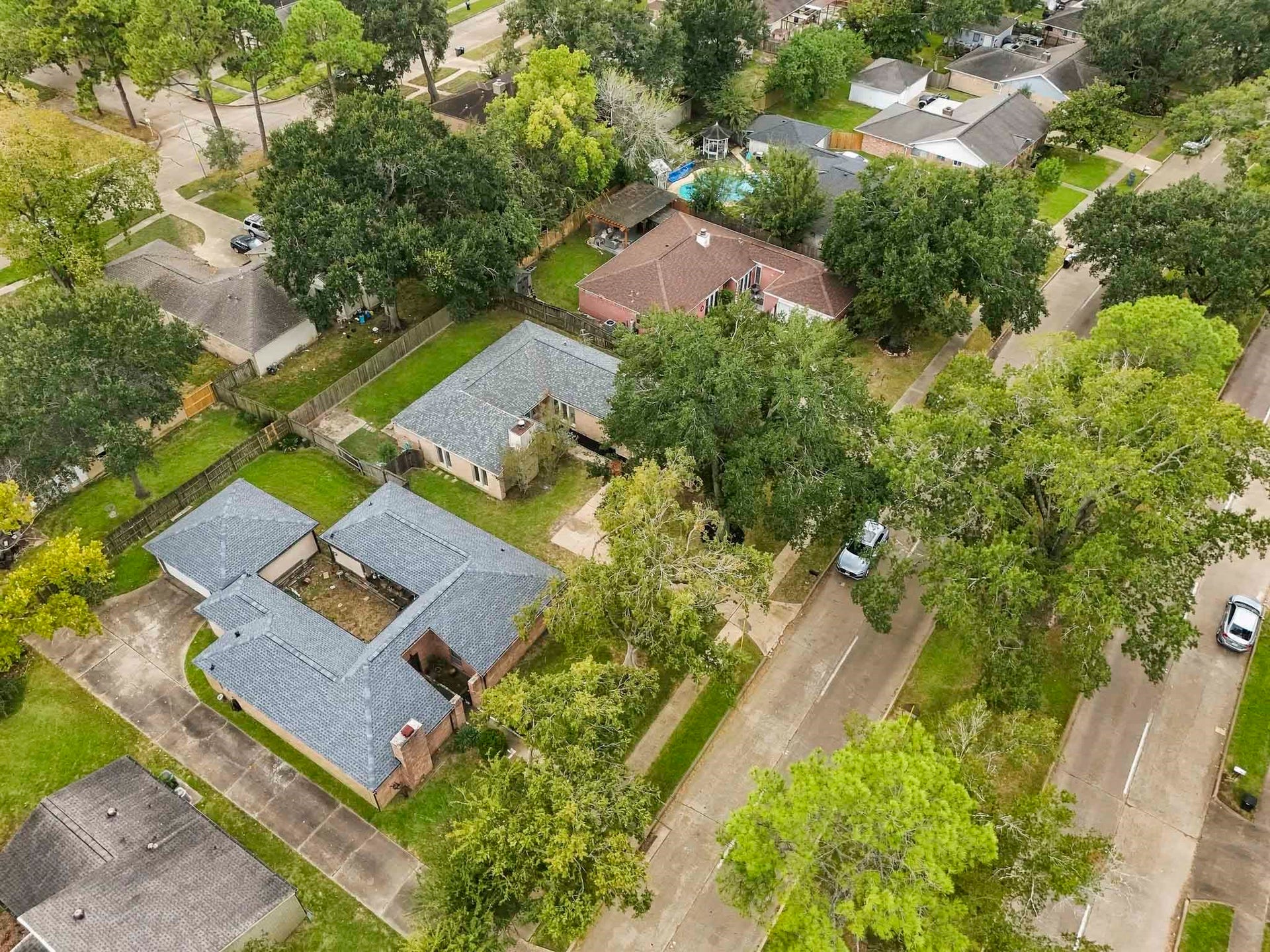 22711 Provincial Boulevard, Katy, TX 77450 Viewed from above, the property stands out for its generous acreage, lush surroundings, and unique single-level configuration.