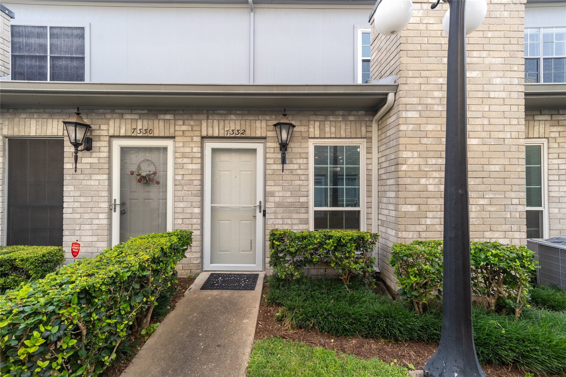7332 Regency Square Court, #7332, Houston, TX 77036 Charming brick exterior with a private landscaped entrance