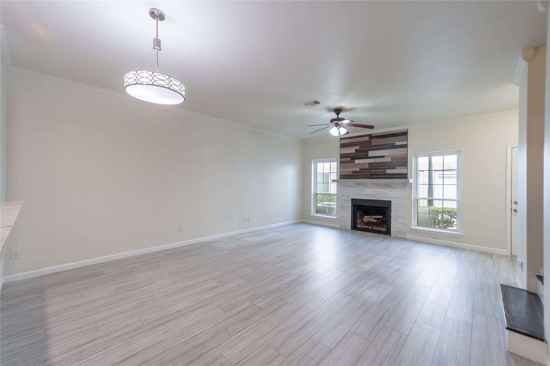 7332 Regency Square Court, #7332, Houston, TX 77036 Spacious living and dining area with a modern fireplace and abundant natural light.