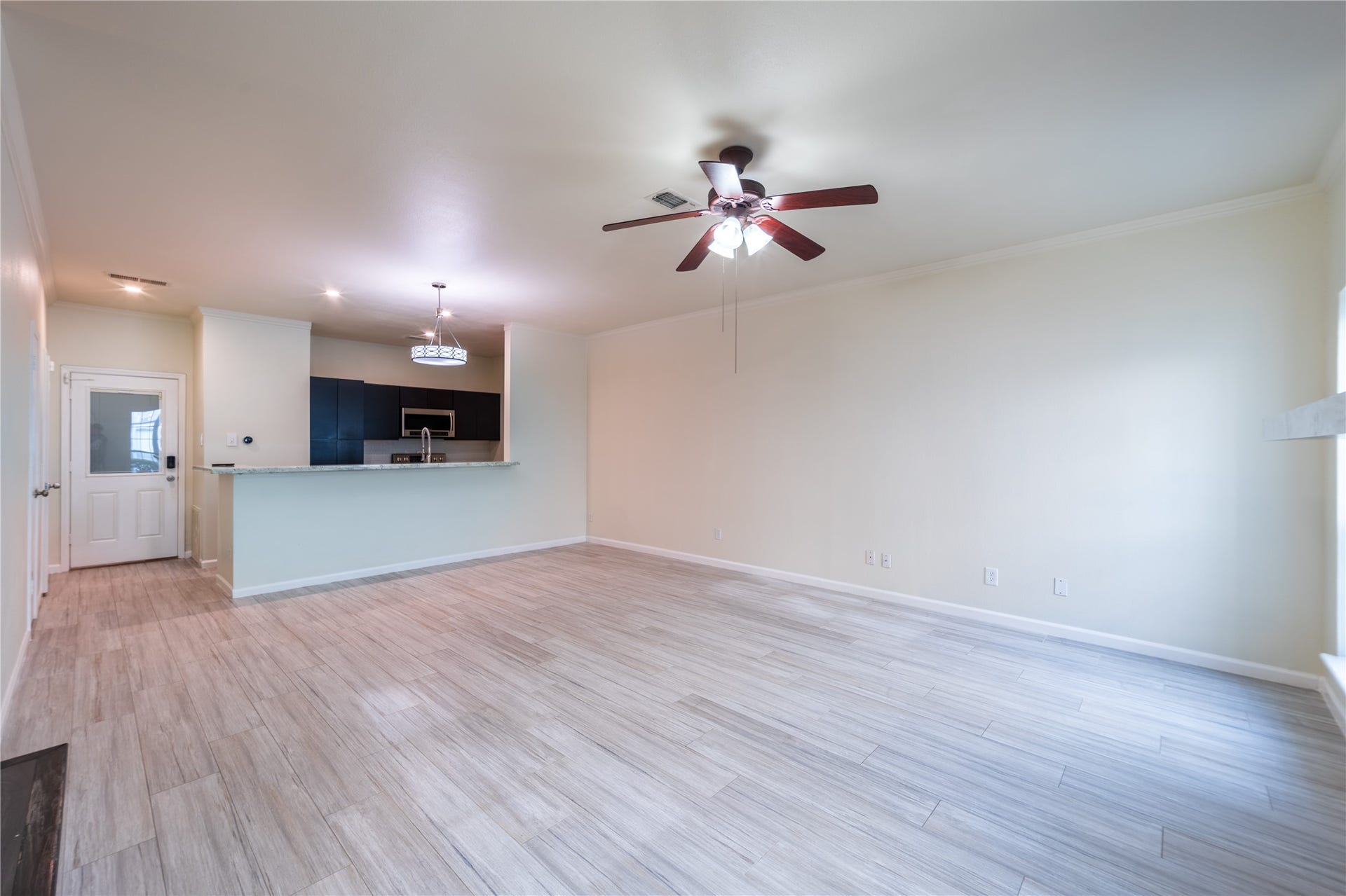 7332 Regency Square Court, #7332, Houston, TX 77036 Bright, open-concept living and dining area with modern flooring