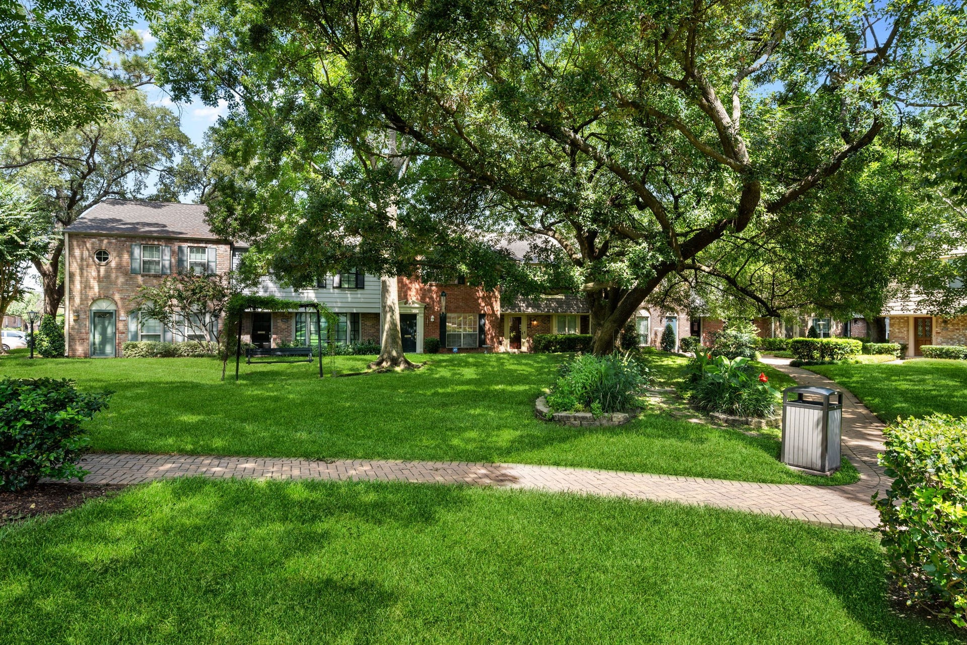 5819 Valley Forge Drive, #91, Houston, TX 77057 Charming townhomes surrounded by lush greenery and mature trees, offering a serene community atmosphere with well-maintained pathways and inviting outdoor spaces.