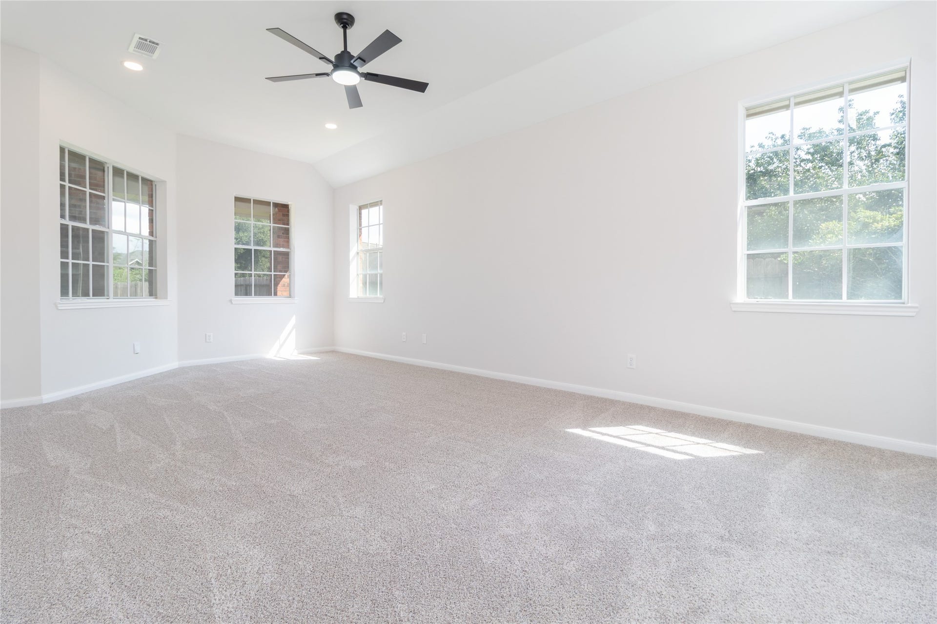 3115 Hickory Grove Lane, Pearland, TX 77584 Primary bedroom. High ceiling, recessed lighting, and new carpet.
