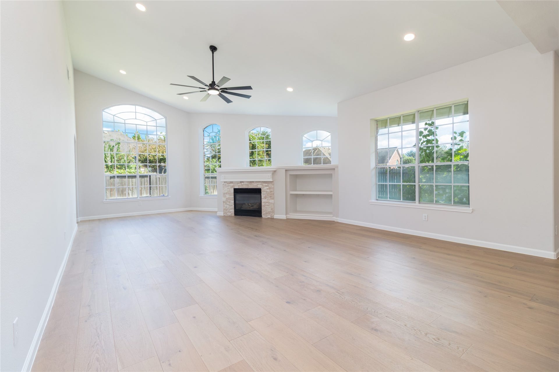 3115 Hickory Grove Lane, Pearland, TX 77584 View of the living room from the kitchen area. Several windows provide beauty and natural light.