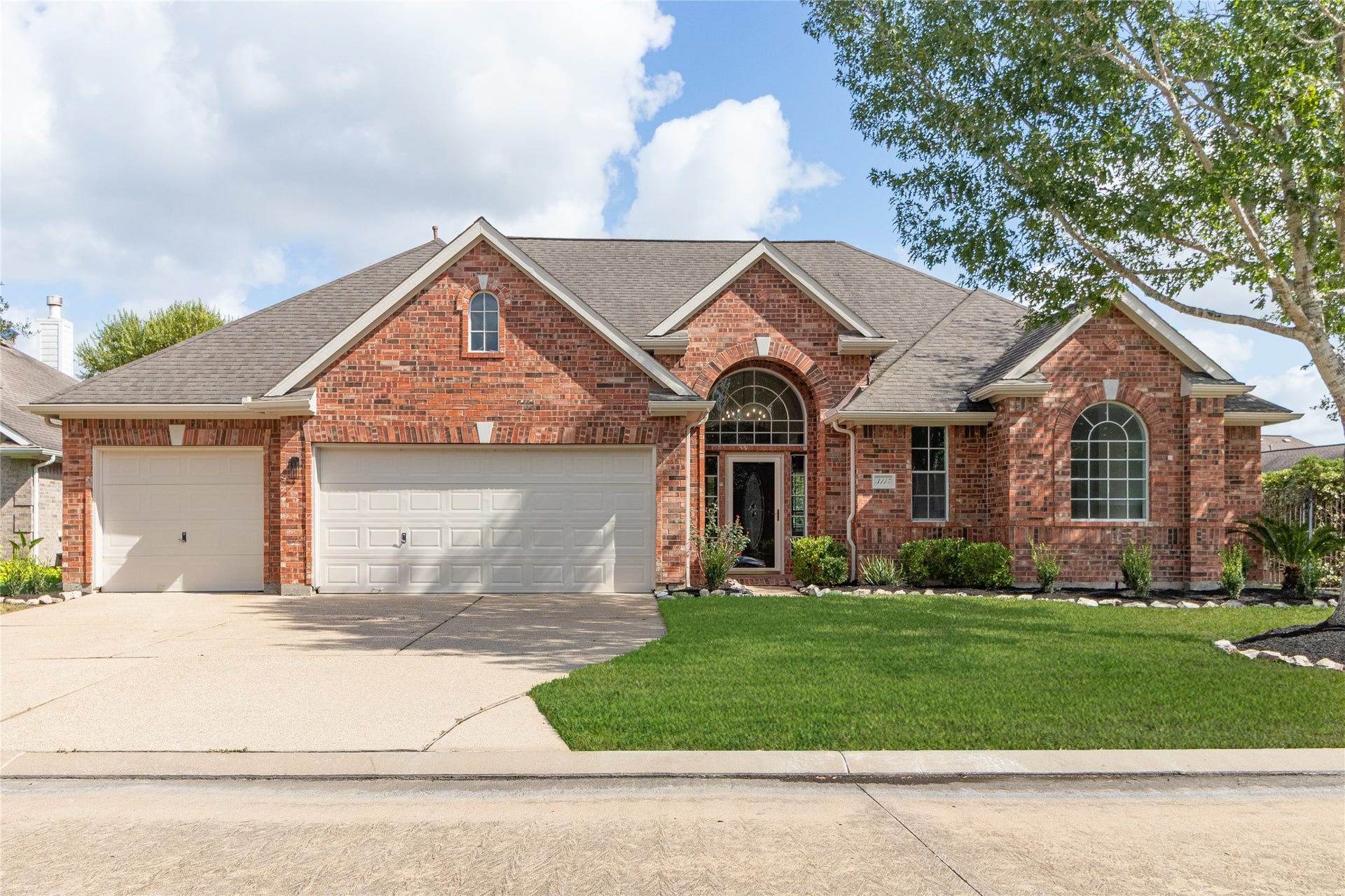 3115 Hickory Grove Lane, Pearland, TX 77584 1-story on a premium corner cul-de-sac lot with a 3-car garage and a wide driveway.