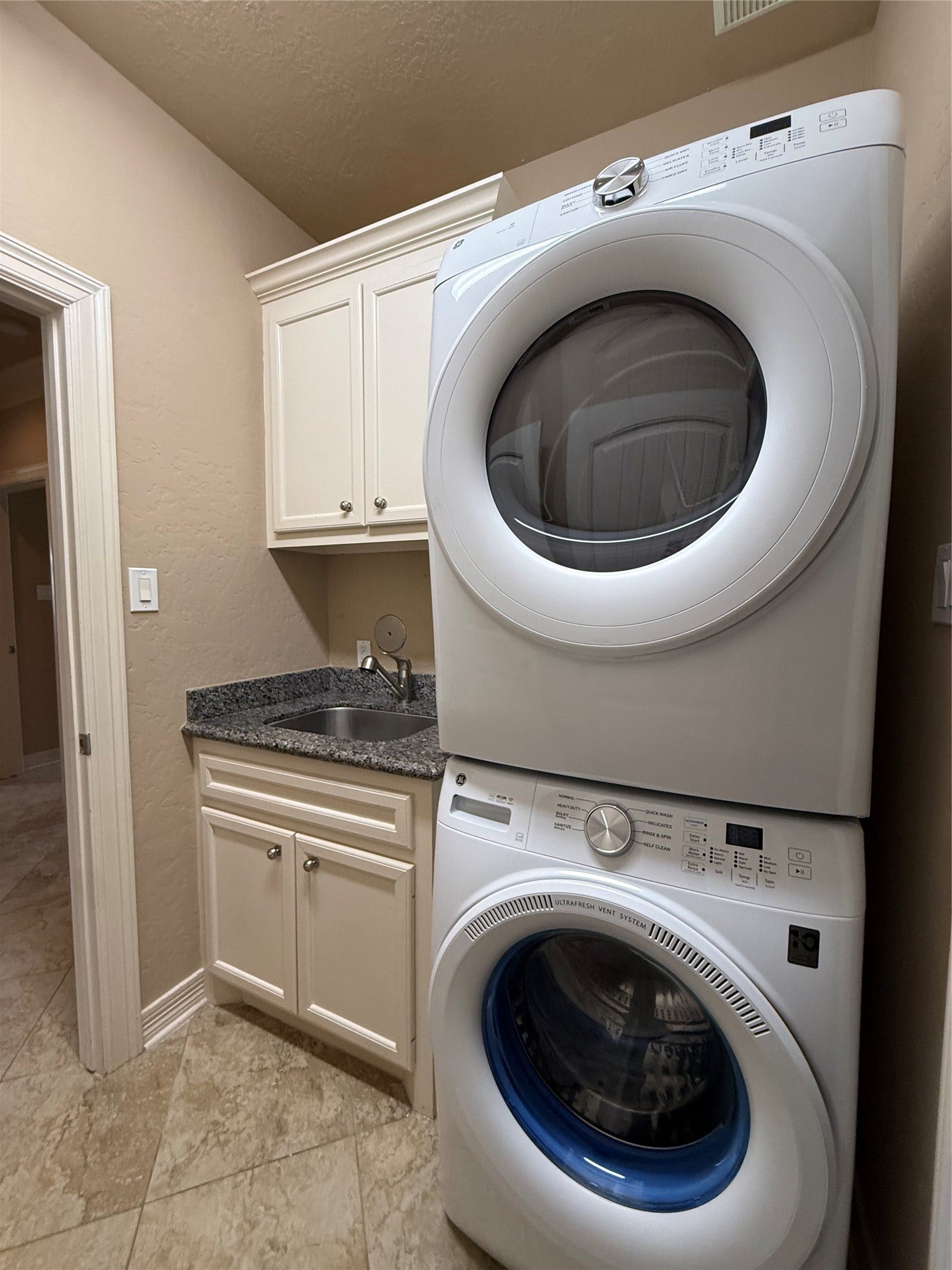 19841 S Plantation Estates Drive, Porter, TX 77365 Laundry room featuring a brand new stacked washer and dryer, sink and storage in utility room.