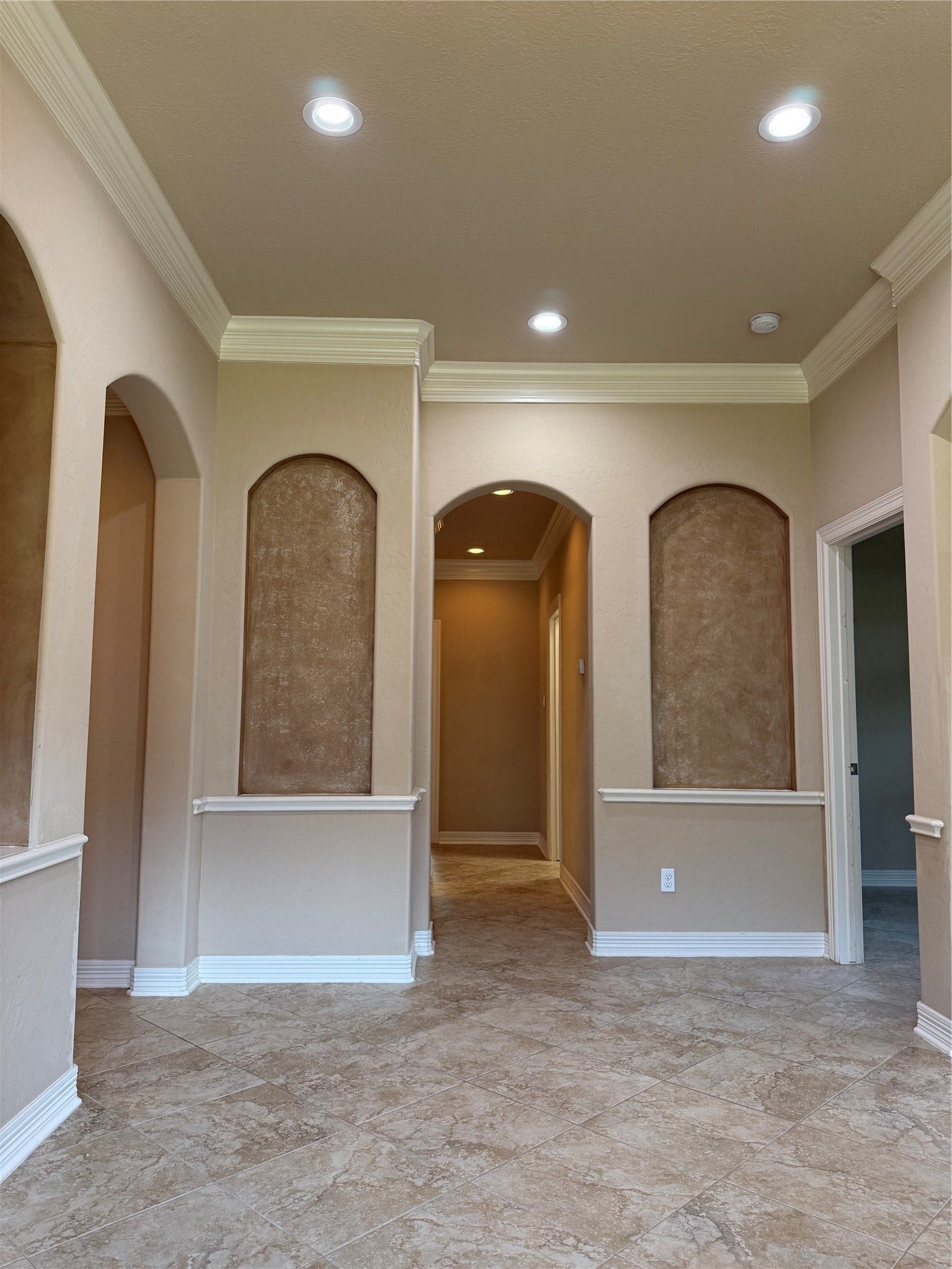 19841 S Plantation Estates Drive, Porter, TX 77365 Elegant entryway featuring recessed lighting, decorative wall niches, and beautiful tile flooring, leading to bedrooms.
