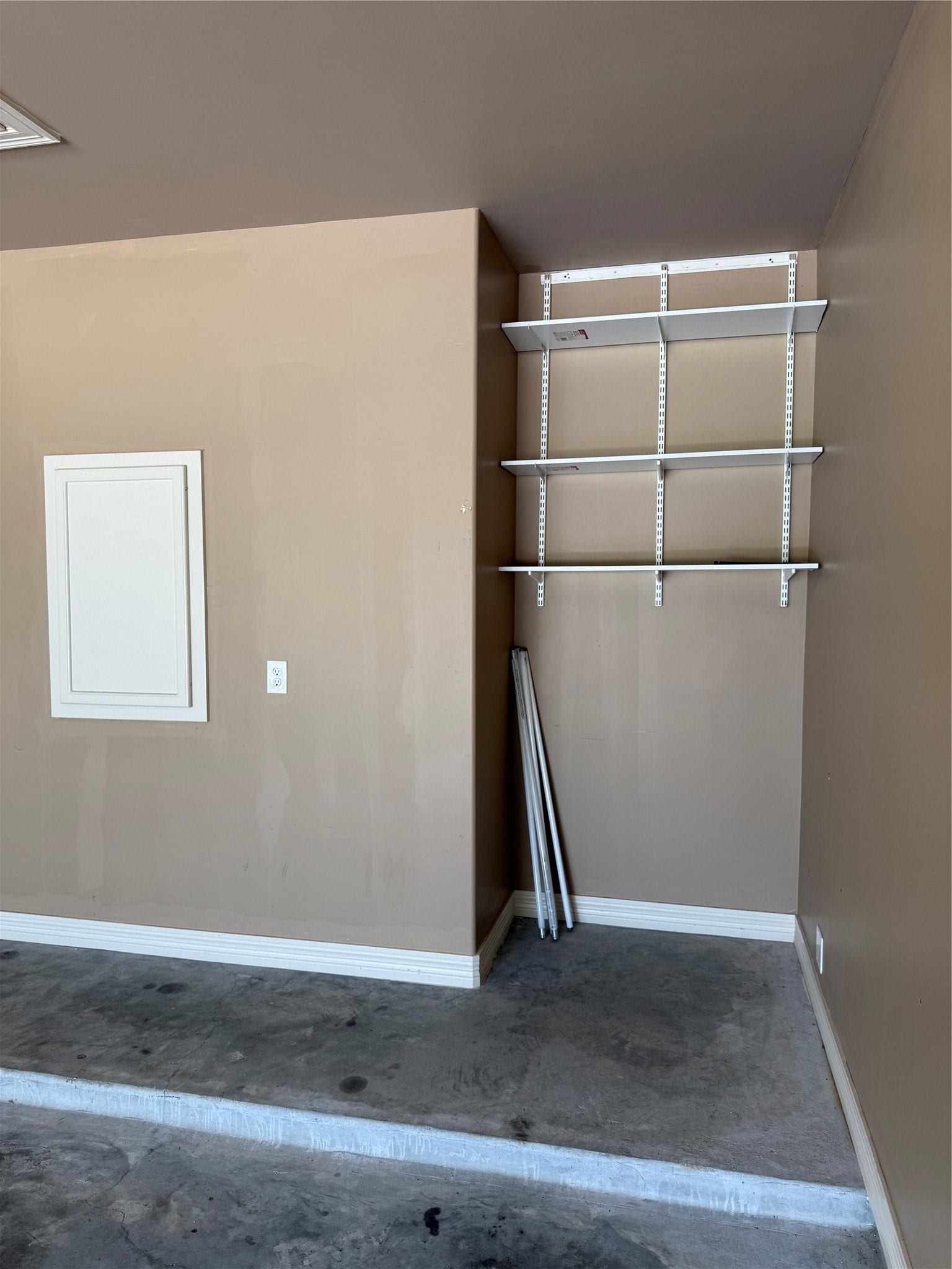 19841 S Plantation Estates Drive, Porter, TX 77365 Spacious garage area featuring built-in shelving for convenient storage and organization.