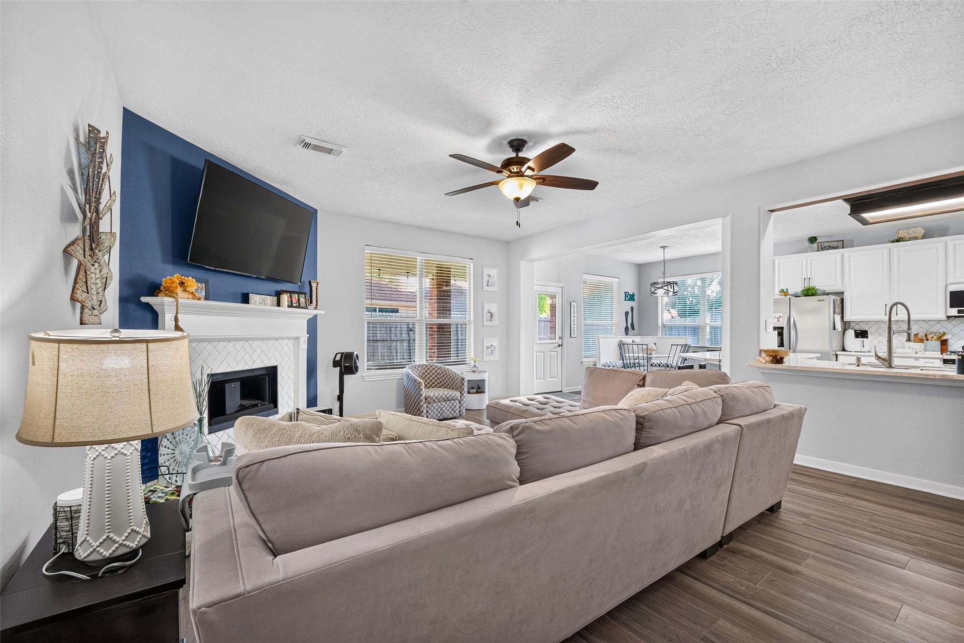 113 Erin Court, La Porte, TX 77571 Sunlit living room with sightlines into the kitchen and dining areas.