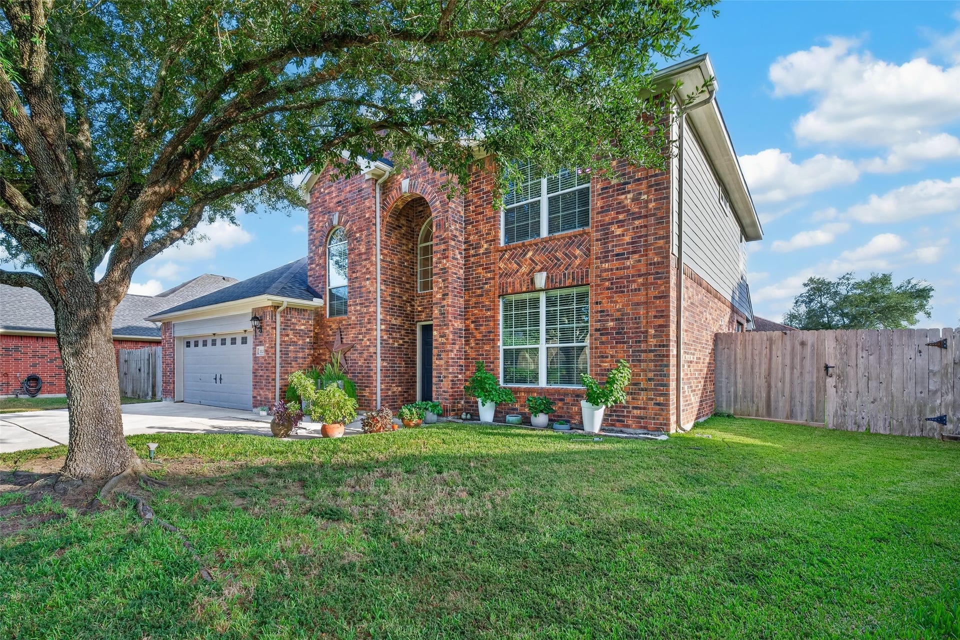 113 Erin Court, La Porte, TX 77571 Angled view showing off the home's curb appeal and spacious driveway.