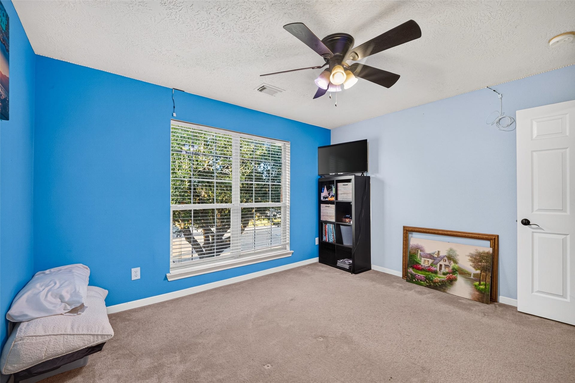 113 Erin Court, La Porte, TX 77571 Cheerful bedroom with blue accent wall and big bright windows.